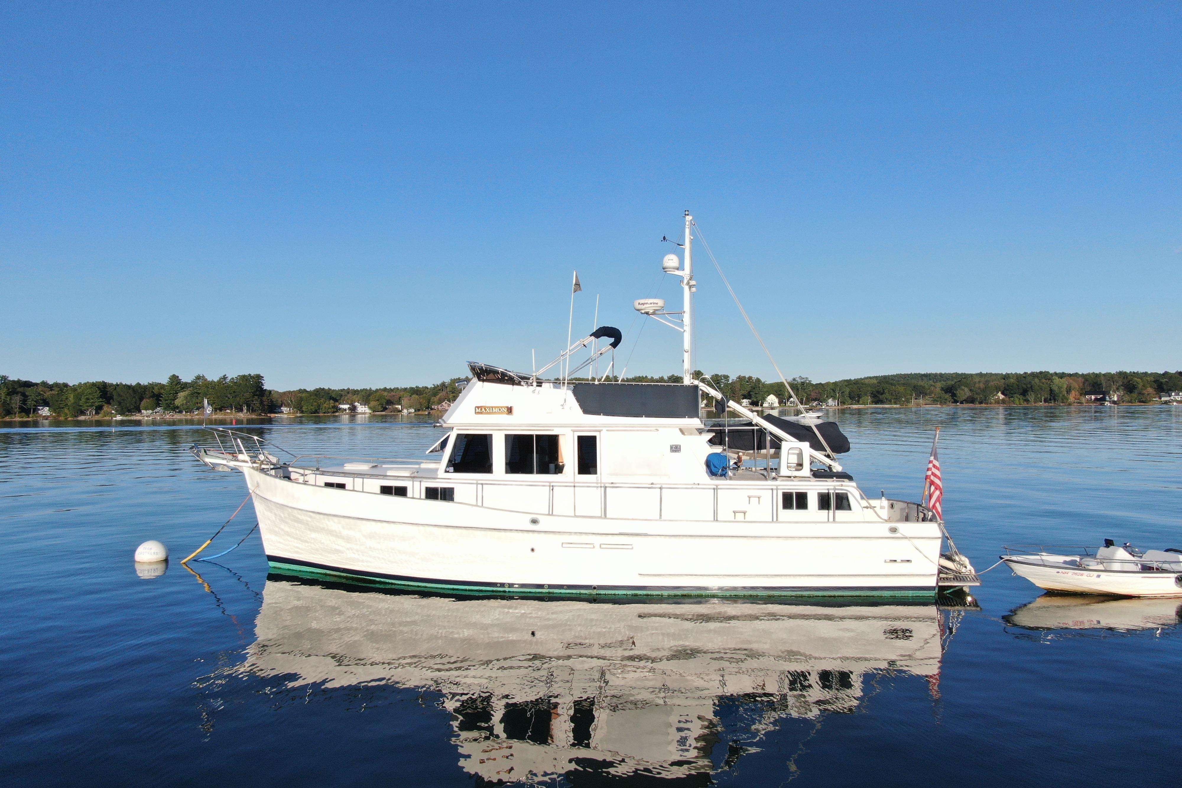 1989 Grand Banks 46 Classic yacht on calm water, clear sky background.