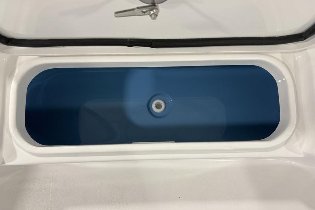 Livewell of 2026 Tidewater 2210 Carolina Bay boat, featuring a sleek blue interior.