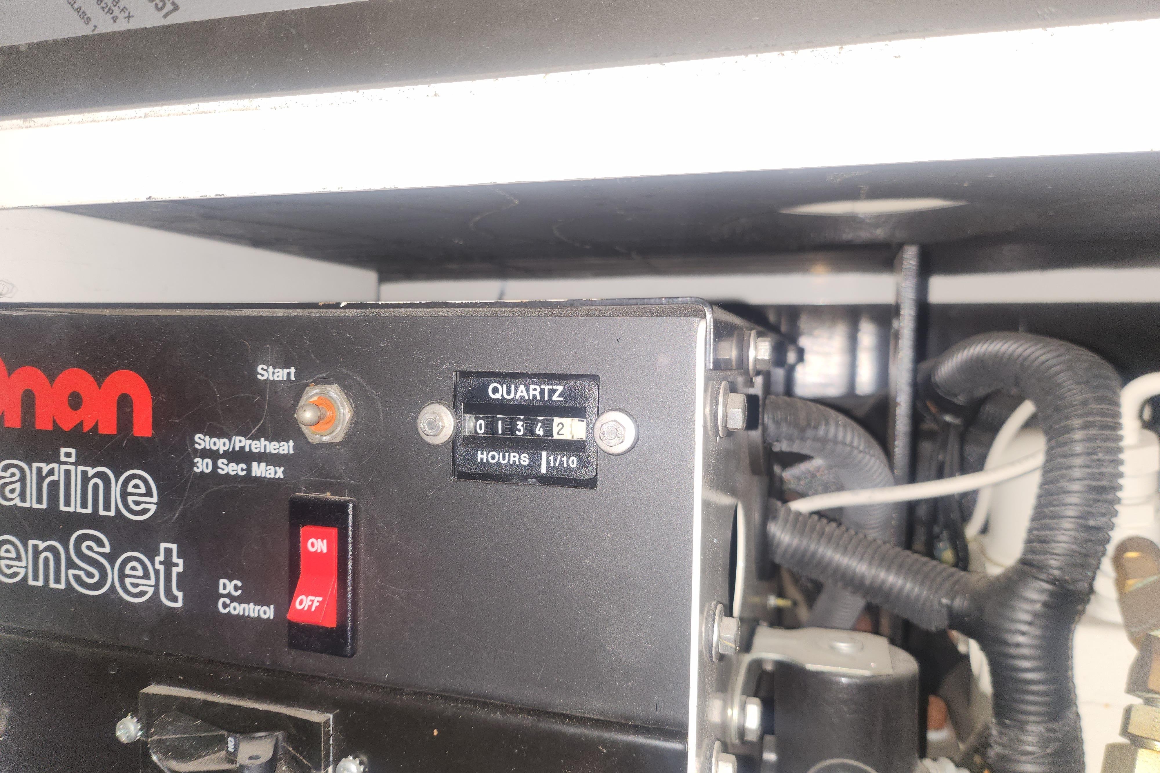 Control panel of a 1997 Mainship 350 Trawler's marine generator set.