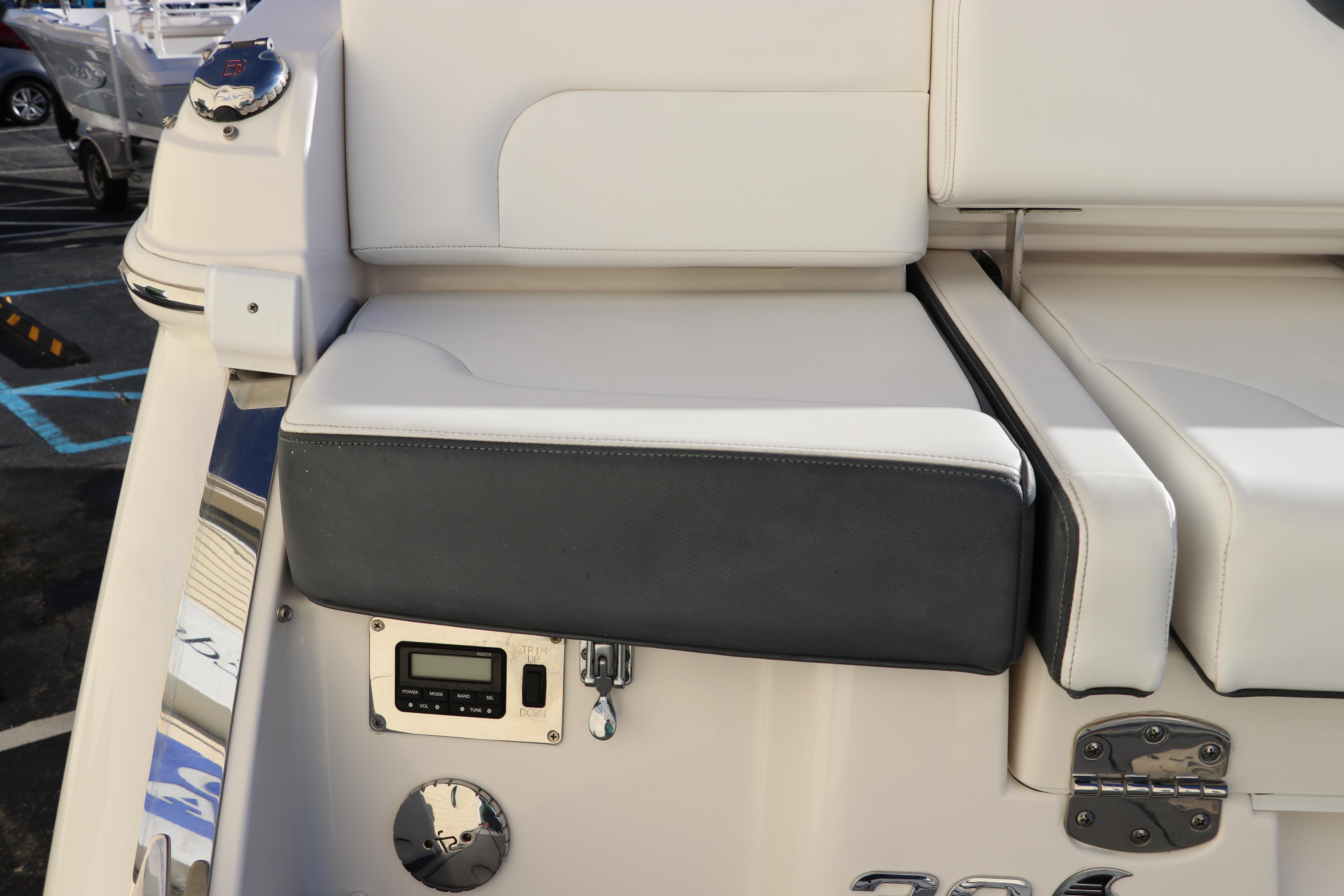 2021 Chaparral 30 Surf boat seating area with control panel and sleek design.