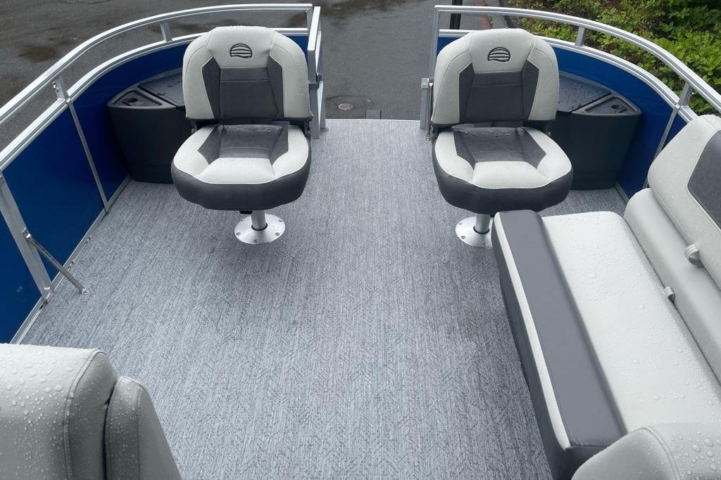 2026 Sun Tracker Fishin' Barge 20 DLX interior with seating and wet deck.