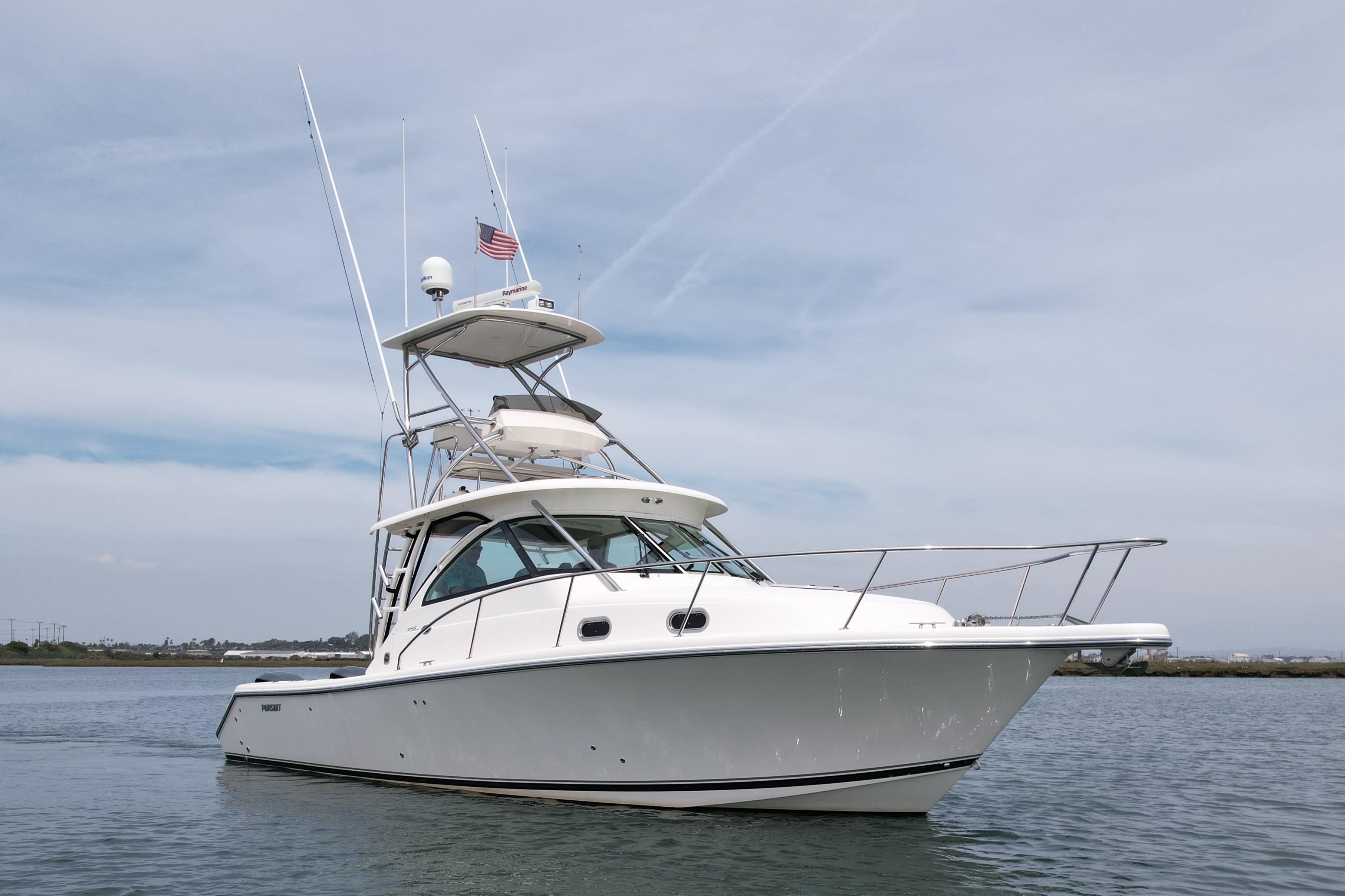 2012 Pursuit OS 345 Offshore boat on calm water under a clear sky.