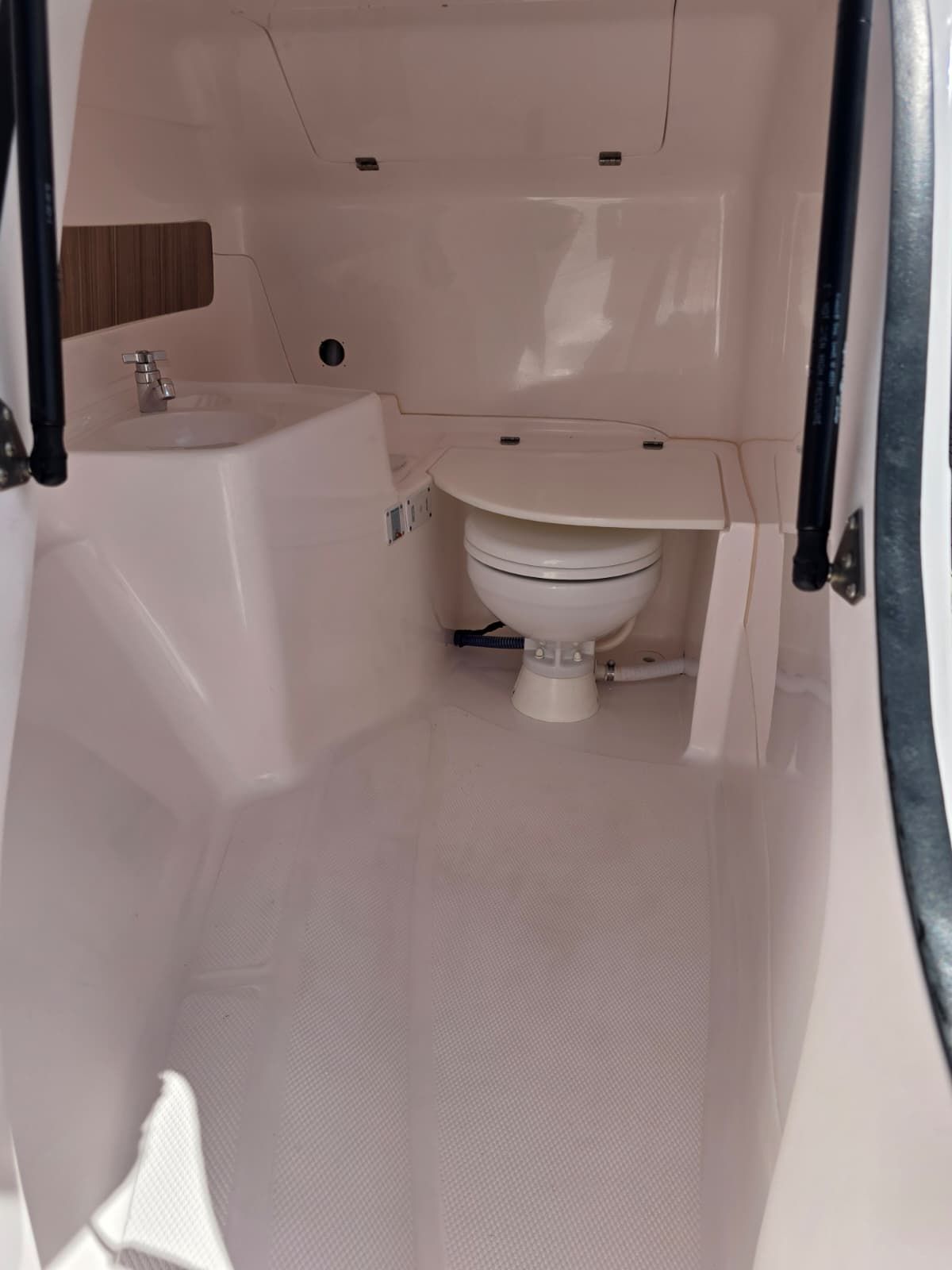 Interior of a 2025 Coral 26 featuring a toilet and sink.
