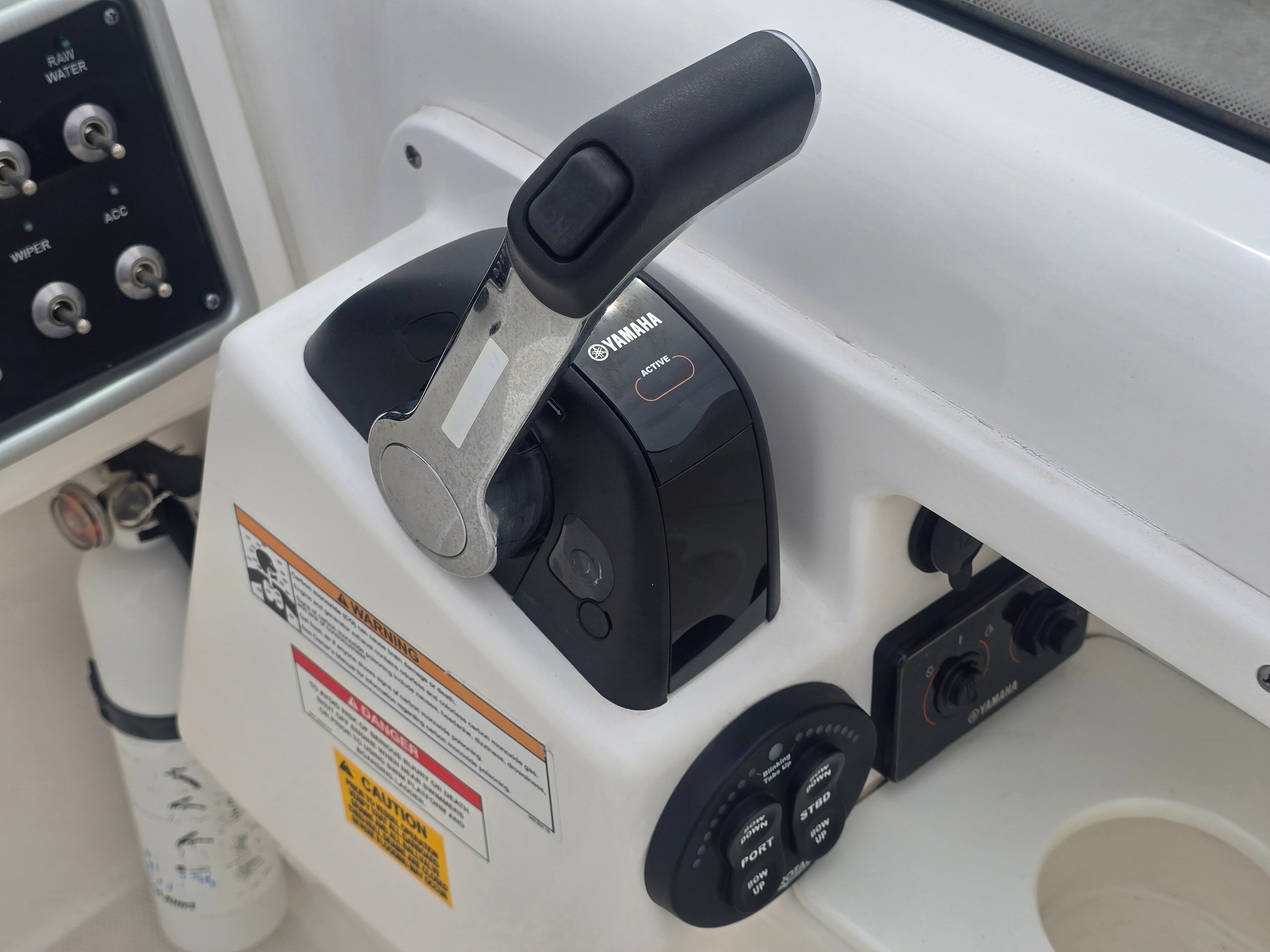 Close-up of a boat's throttle lever and controls.