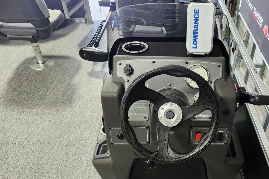 2026 Sun Tracker Bass Buggy 18 DLX dashboard with steering wheel and Lowrance device.