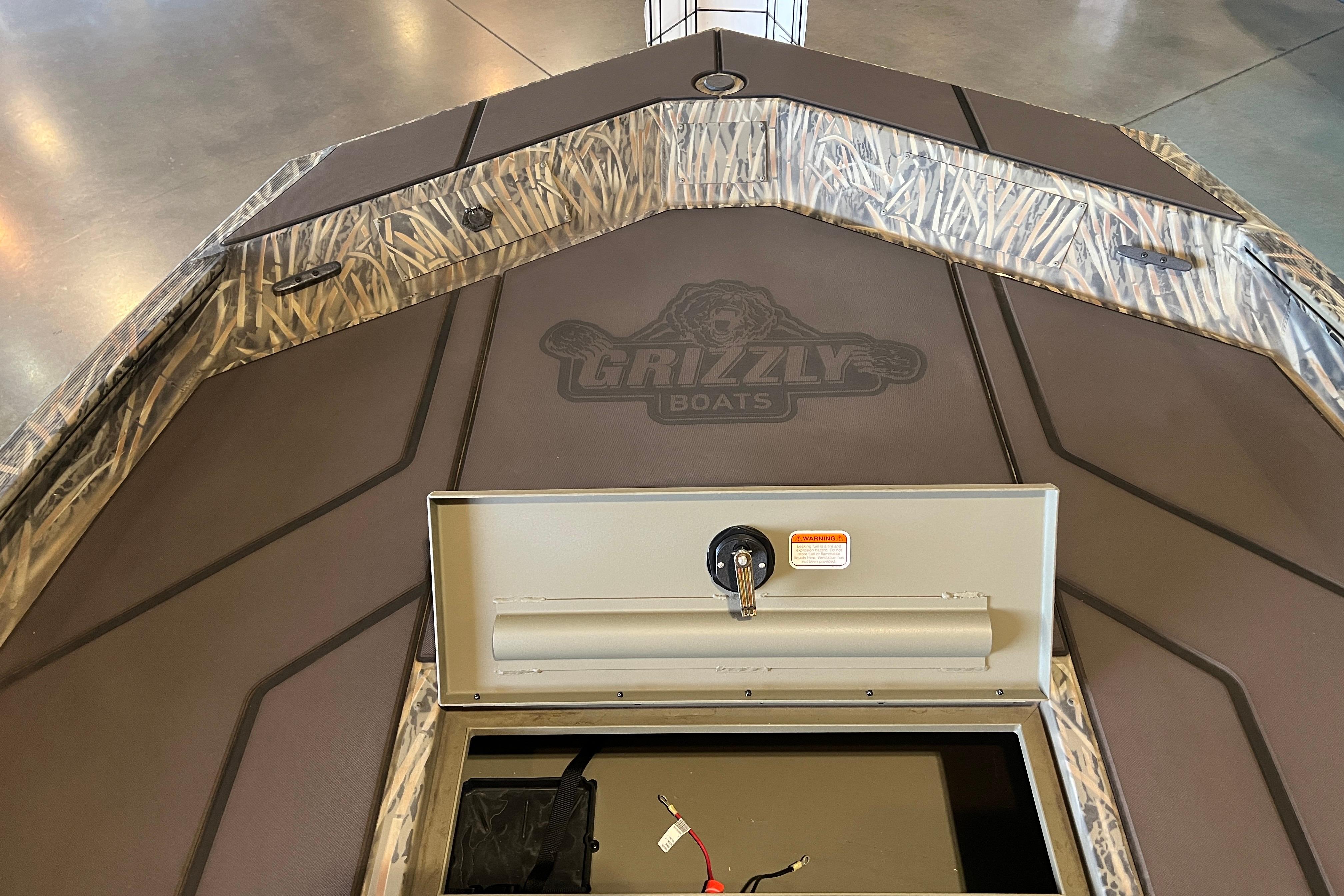 2026 Tracker Grizzly 1860 CC boat interior with camo design and storage compartment.