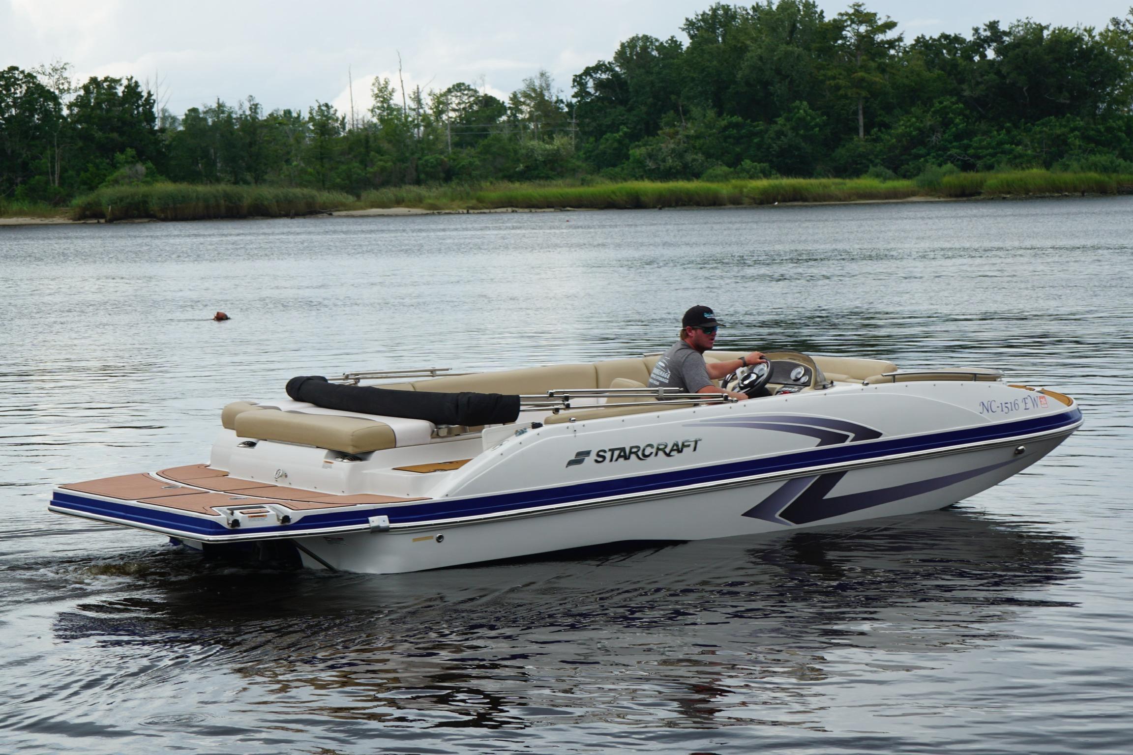 2017 Starcraft Star Step 221 I/O boat cruising on a calm lake.