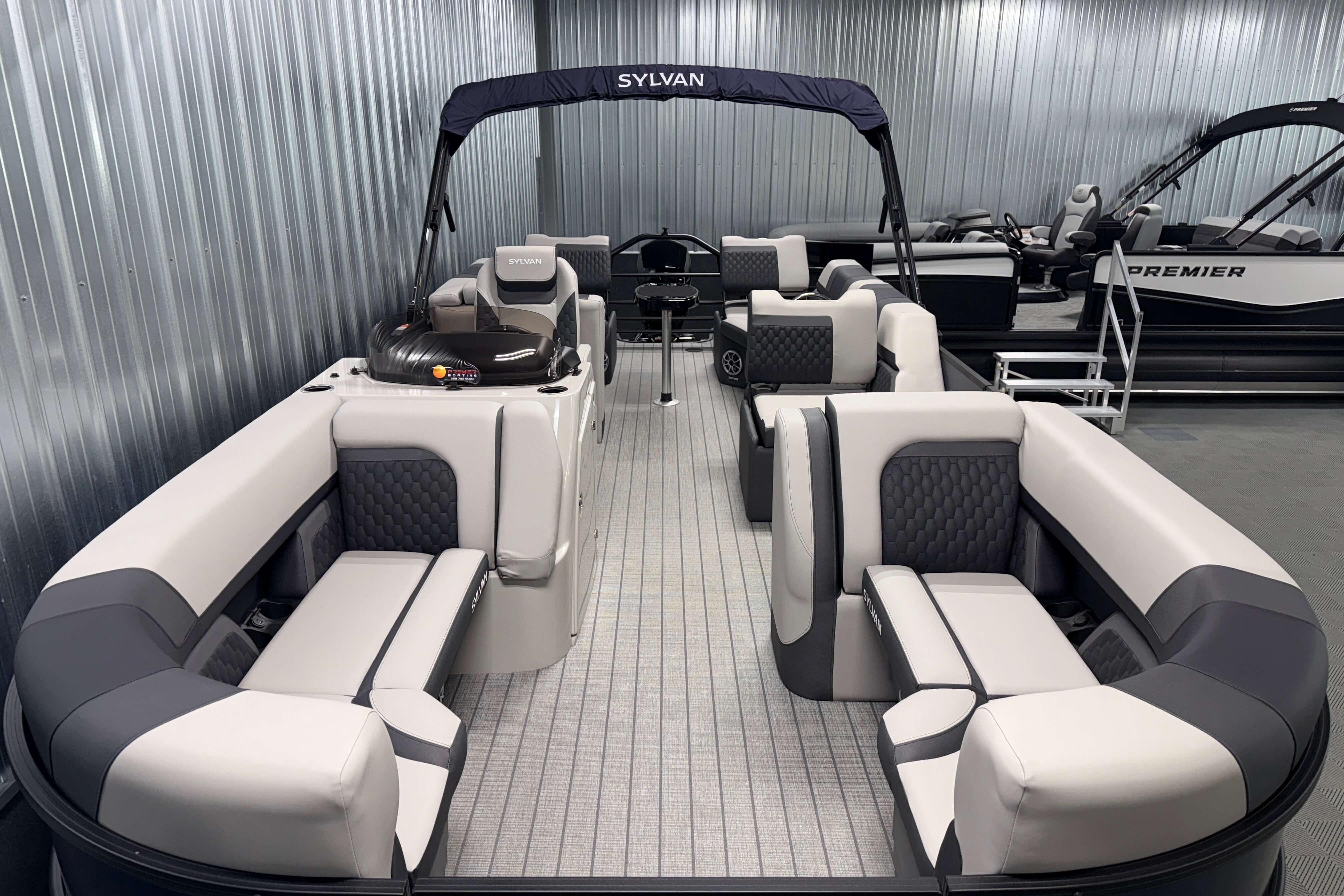 2026 Sylvan L3 SLZ pontoon boat with luxurious seating and modern design in showroom.