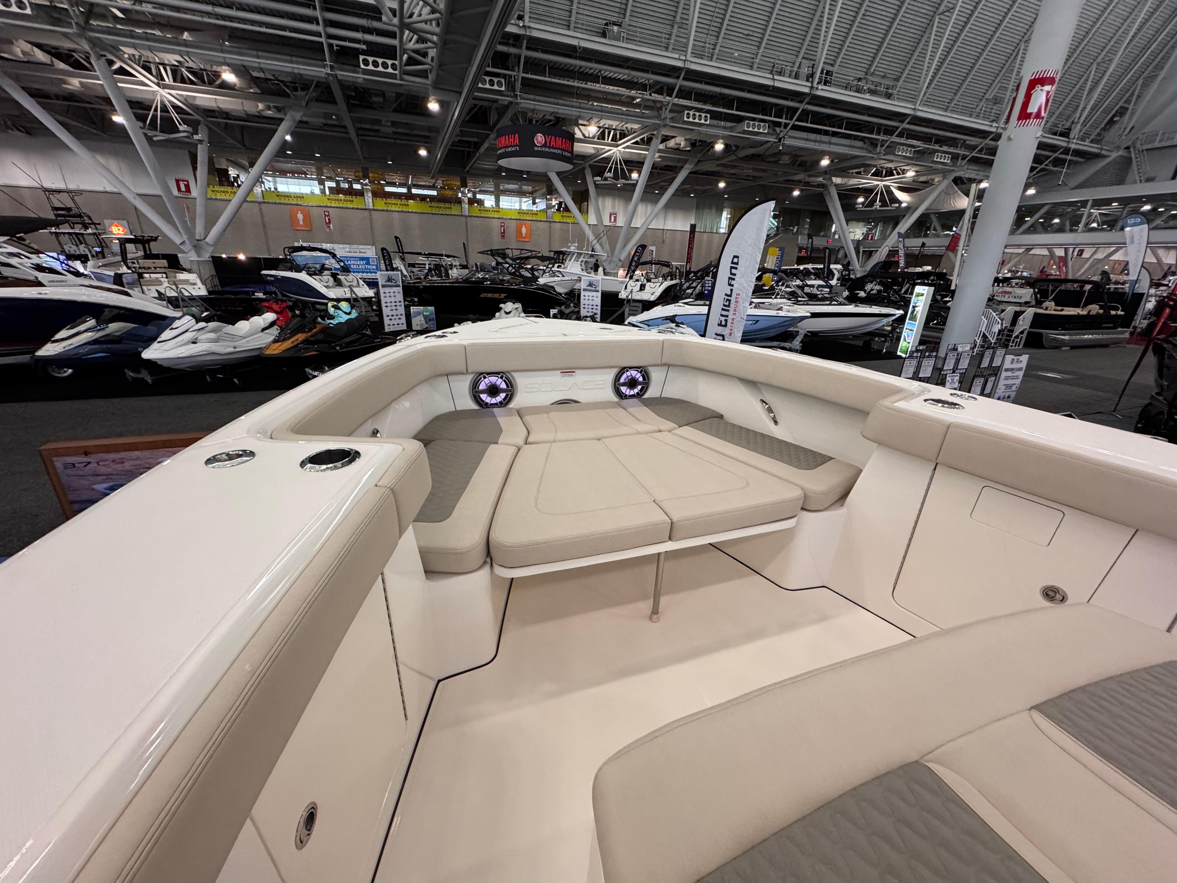 Solace 37 CS 2025 boat interior at a boat show, featuring spacious seating and modern design.