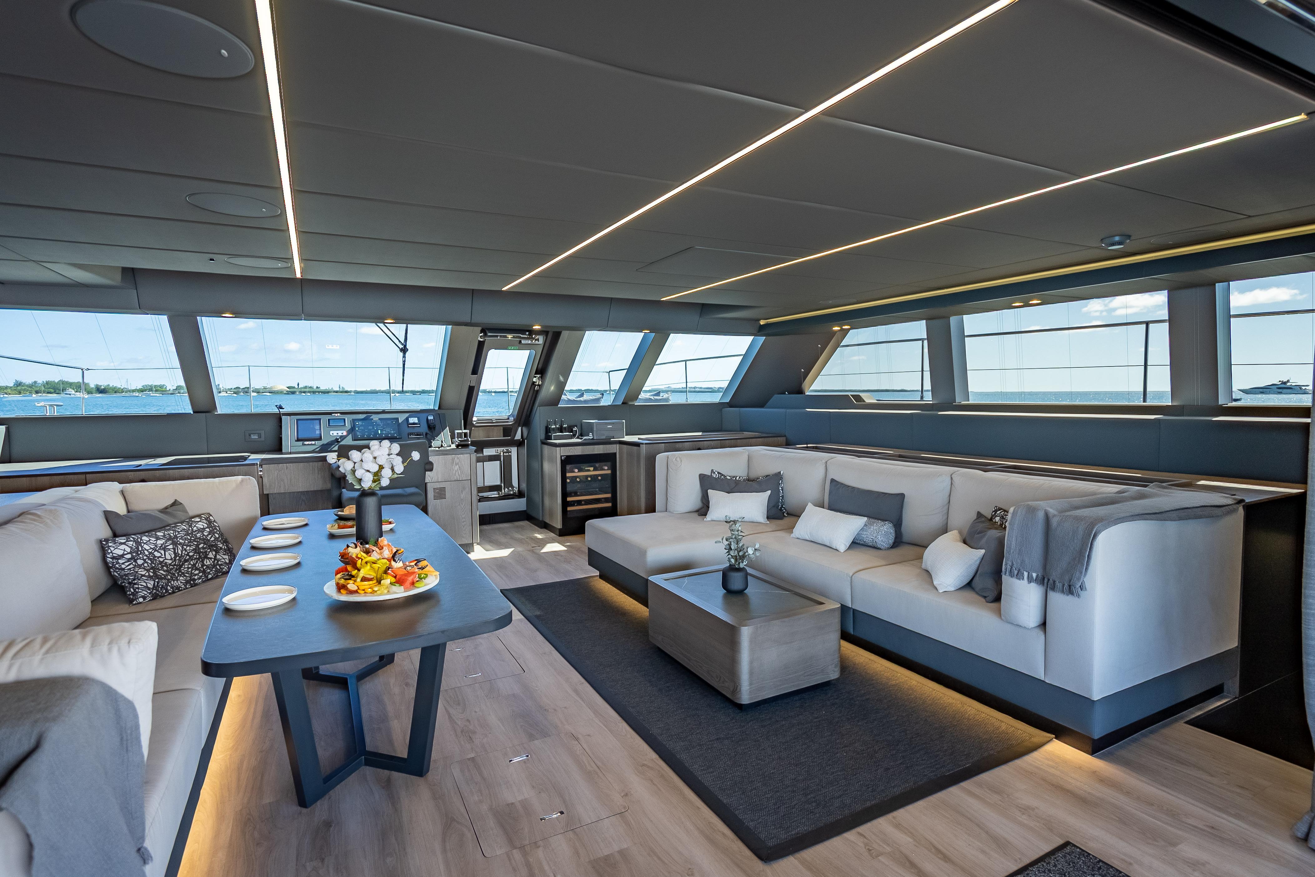 Luxurious interior of 2026 Sunreef 60 Power yacht with elegant seating and dining area.