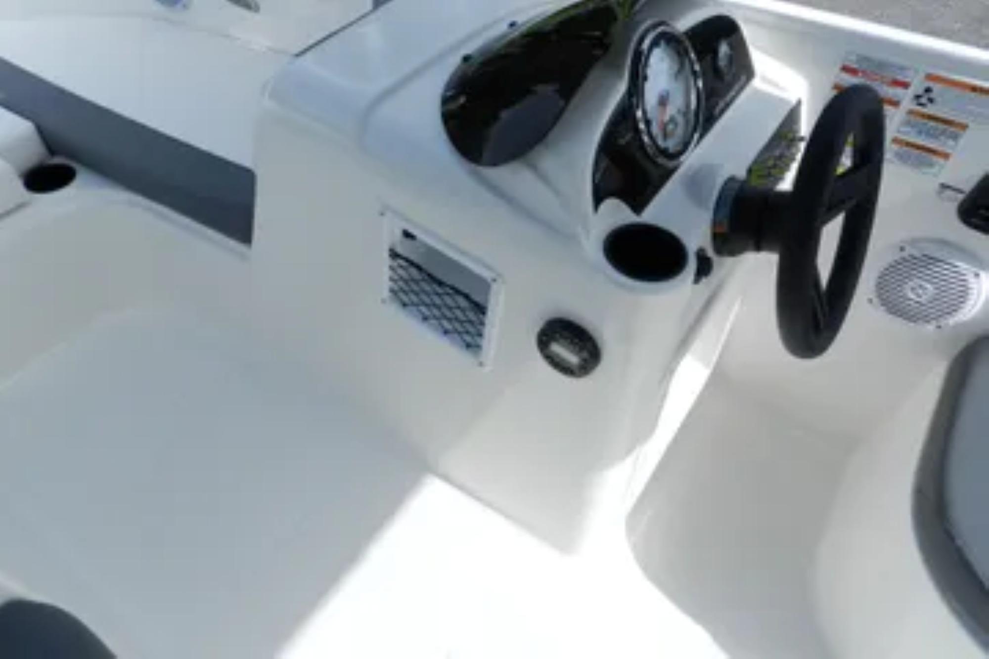 2026 Bayliner Element E18 boat dashboard with steering wheel and controls.