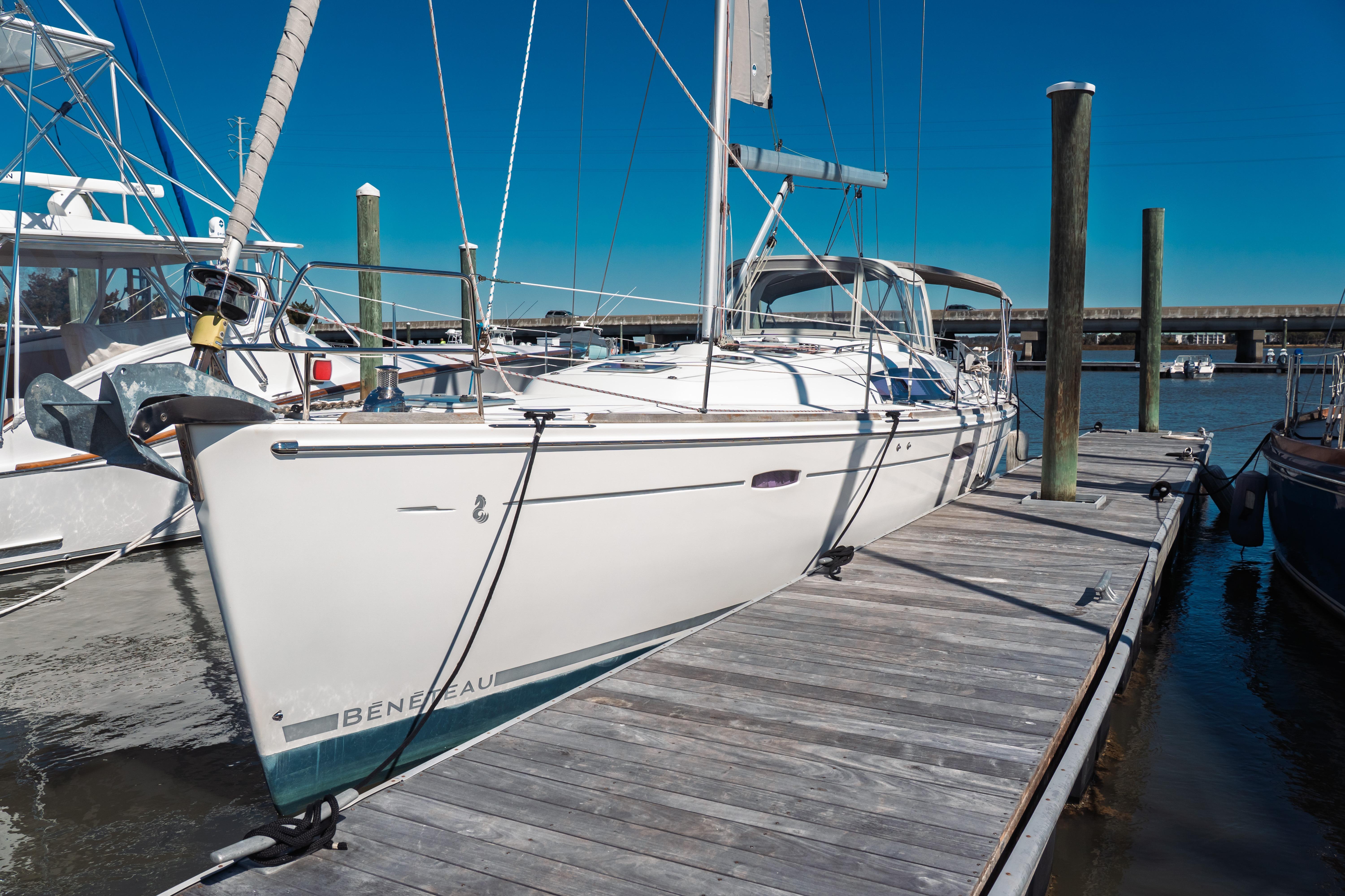 2011 Beneteau Oceanis 50 sailboat docked at marina under clear blue sky.