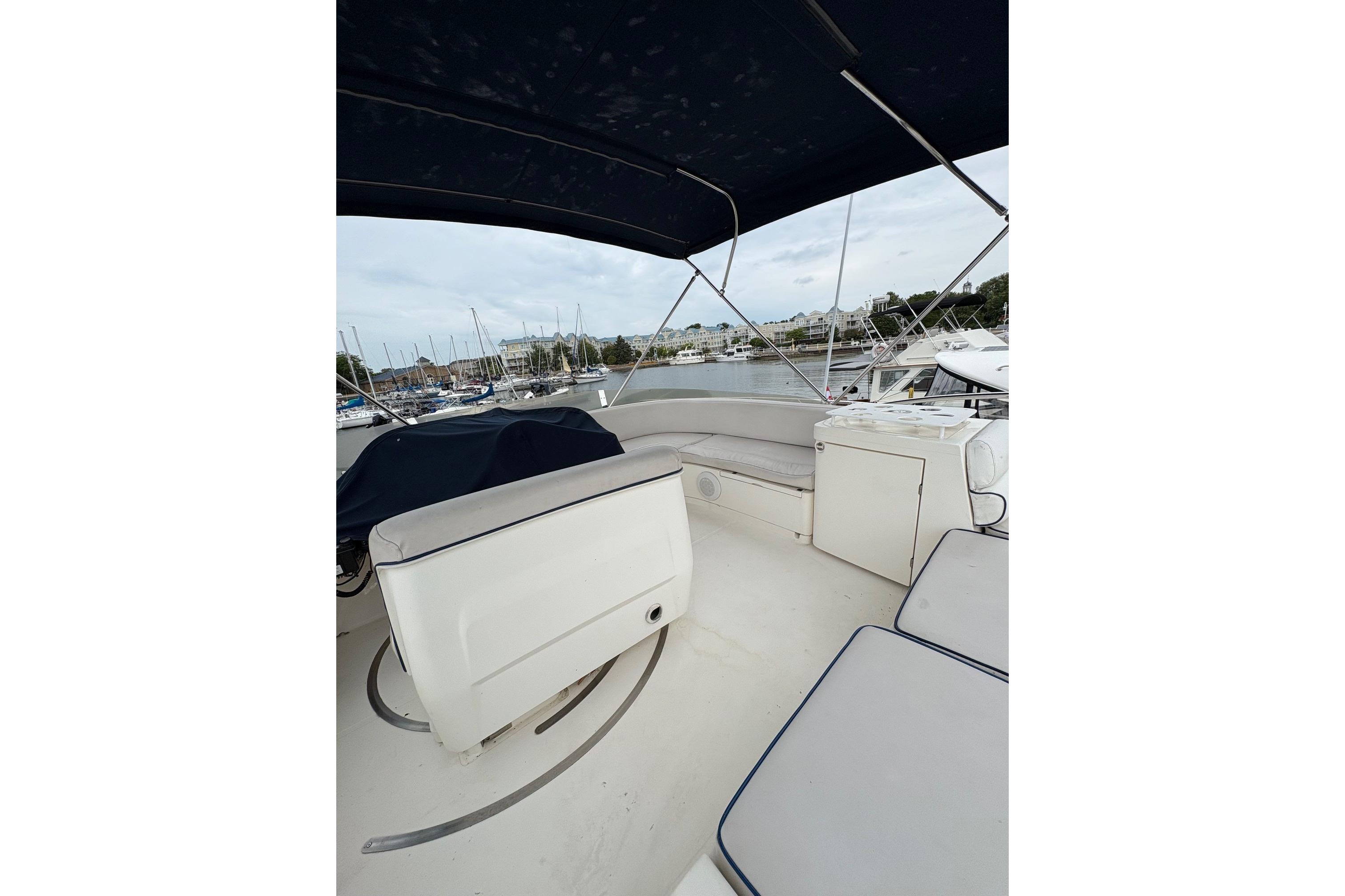 2003 Sealine F42/5 yacht interior with seating and marina view.