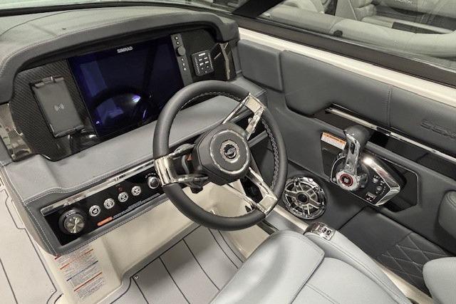 2026 Chaparral SSX 8 boat cockpit with modern steering wheel and control panel.