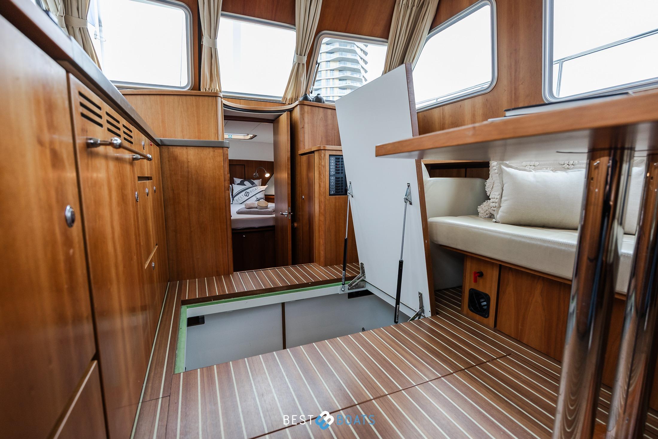 Interior of 2014 Linssen Grand Sturdy 34.9 AC yacht with wood finish and seating area.