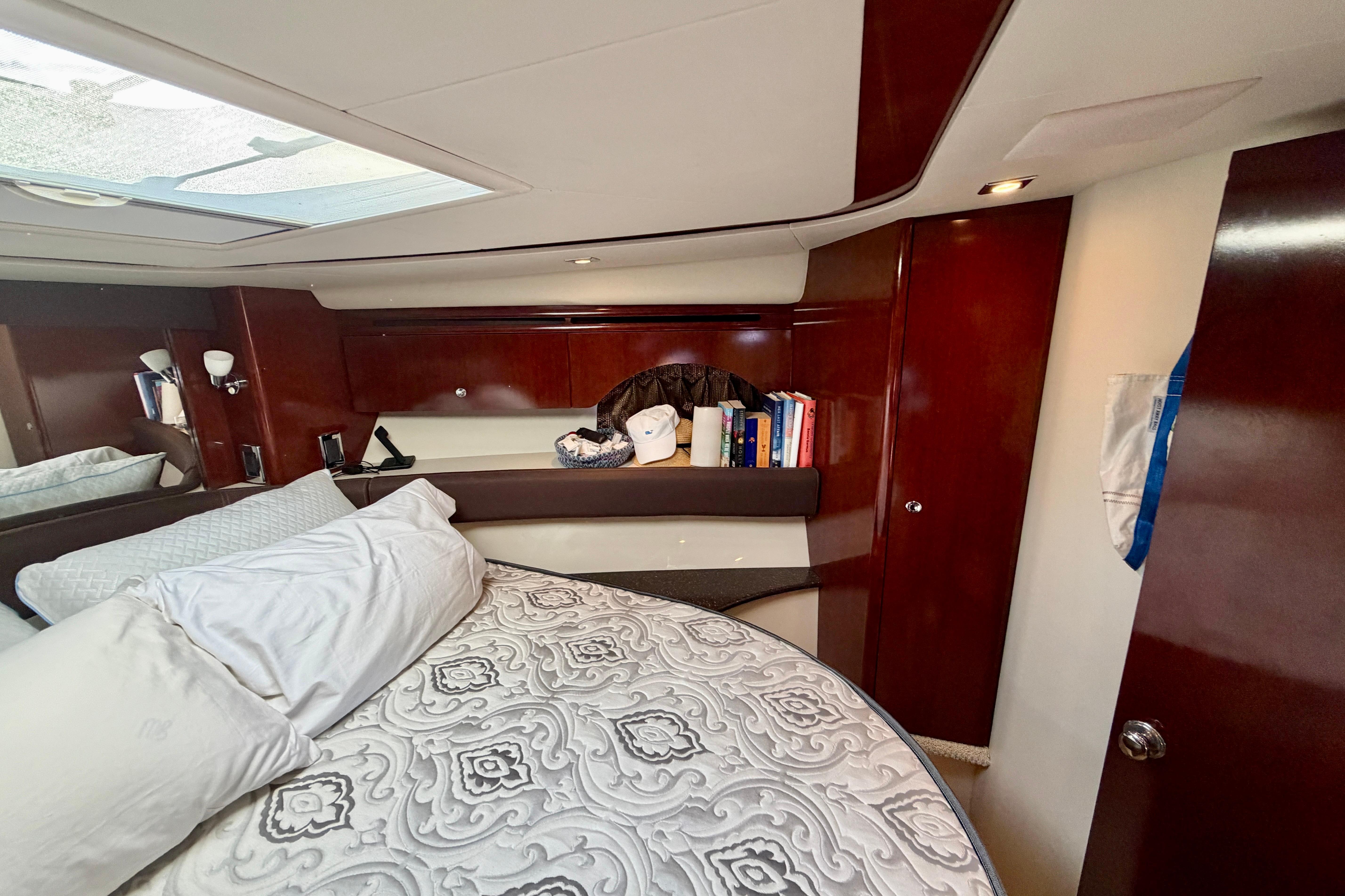 Luxurious cabin interior of 2011 Meridian 441 Sedan yacht with elegant wood finish.