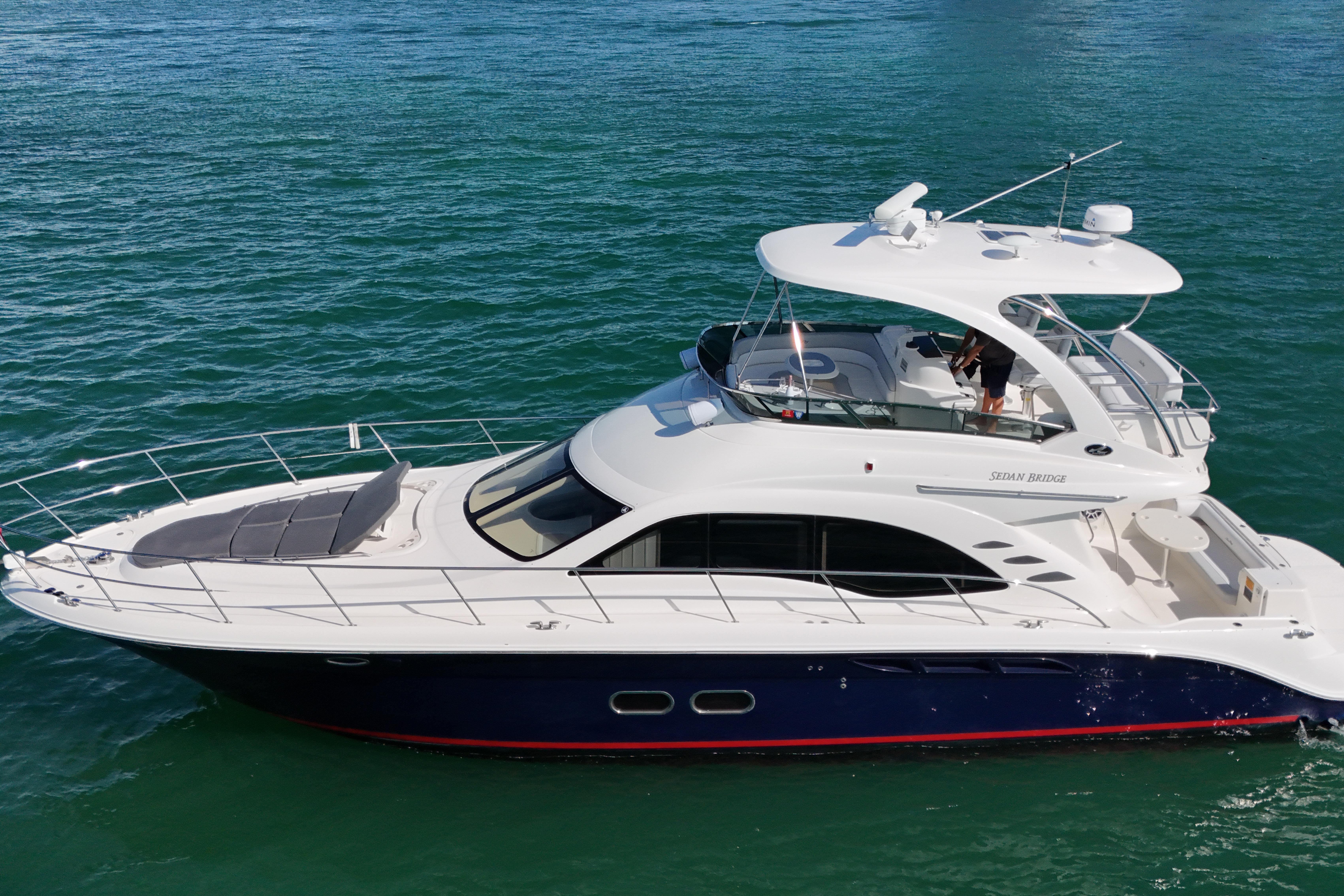 2007 Sea Ray 52 Sedan Bridge yacht cruising on clear blue water.