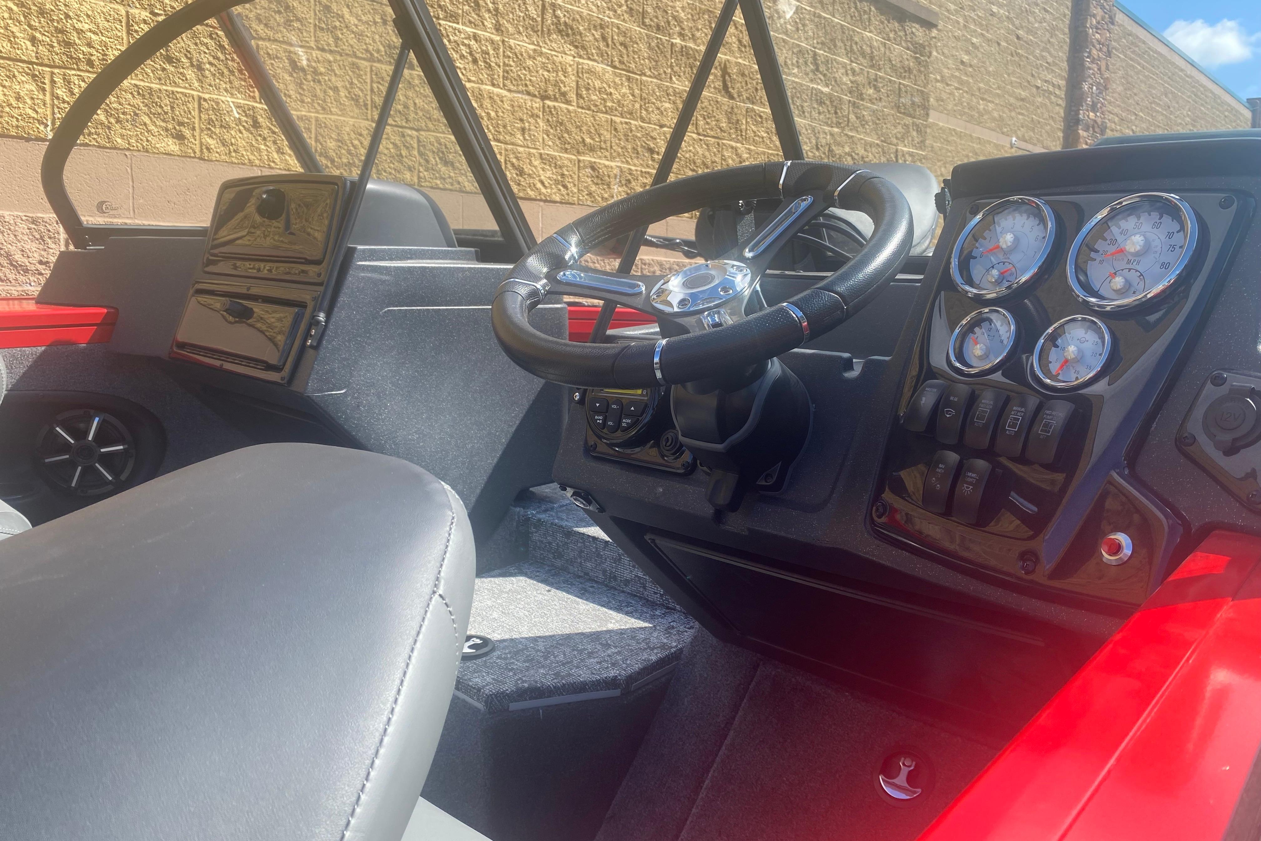Interior view of 2026 Tracker Targa V-18 WT boat, featuring steering wheel and dashboard controls.