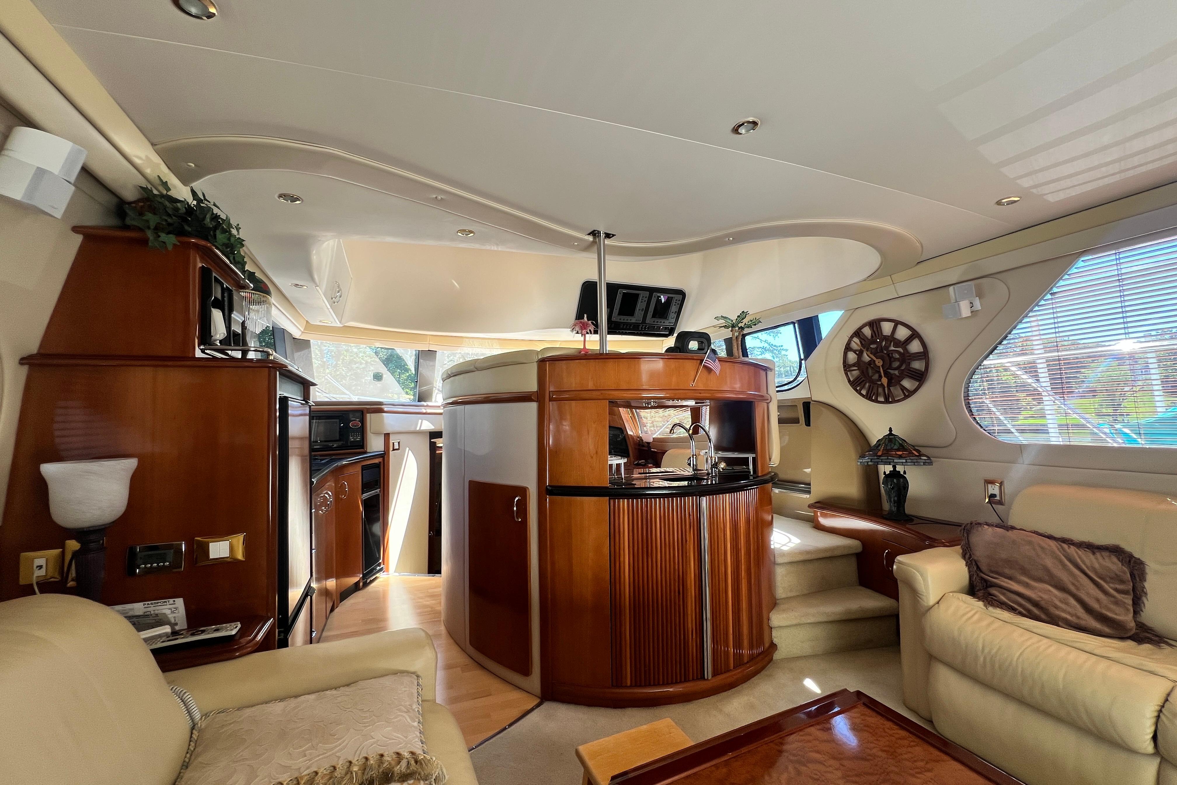 Luxurious interior of 2003 Carver 450 Voyager Pilothouse yacht with elegant wood finishes.