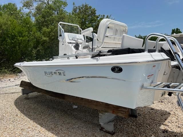 2021 Blue Wave 2200 PureBay boat parked on gravel.