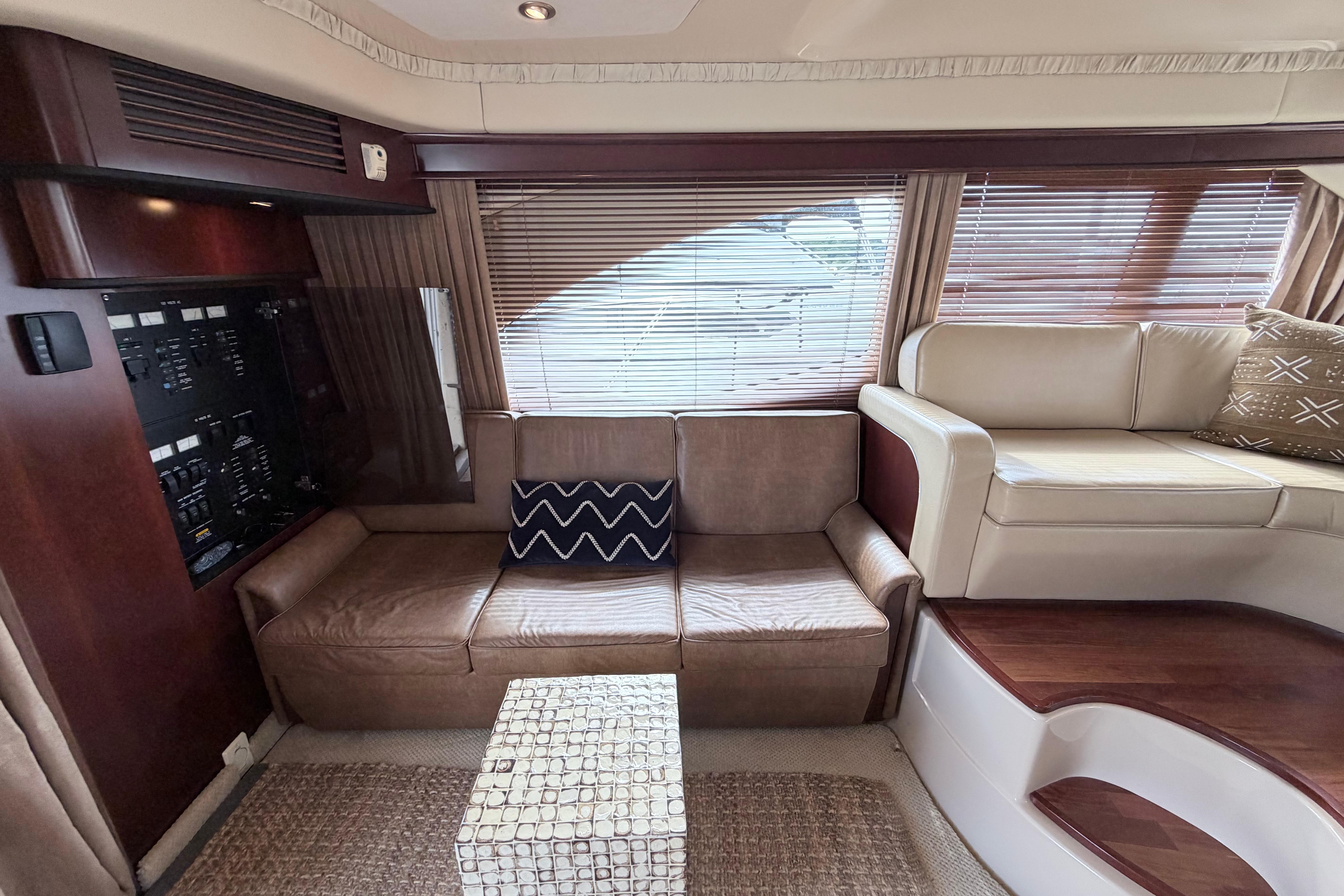 Luxurious interior of 2005 Sea Ray 420 Sedan Bridge yacht with leather seating and wood accents.