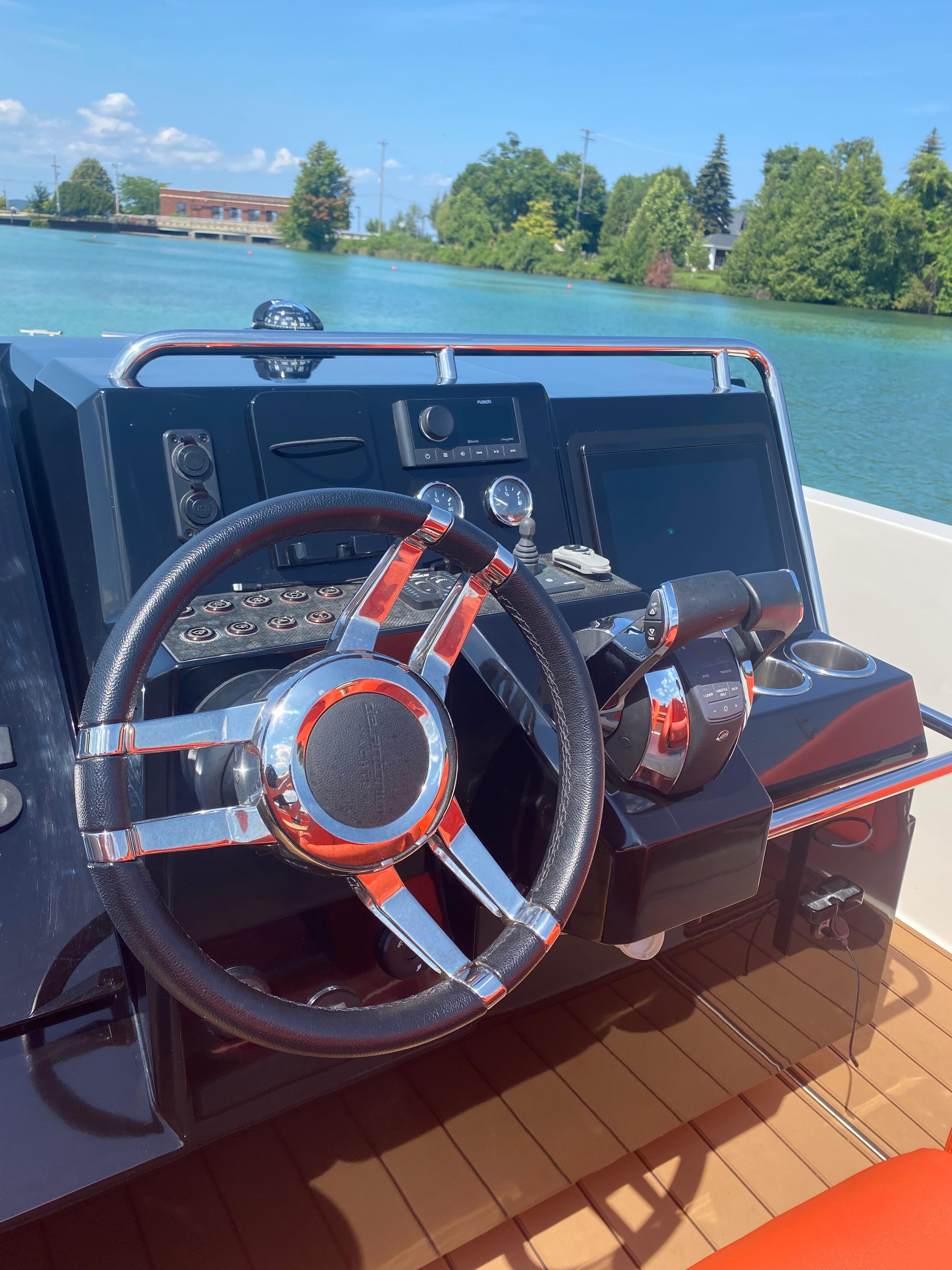 Steering console of 2020 De Antonio Yachts D 28 on a sunny day.