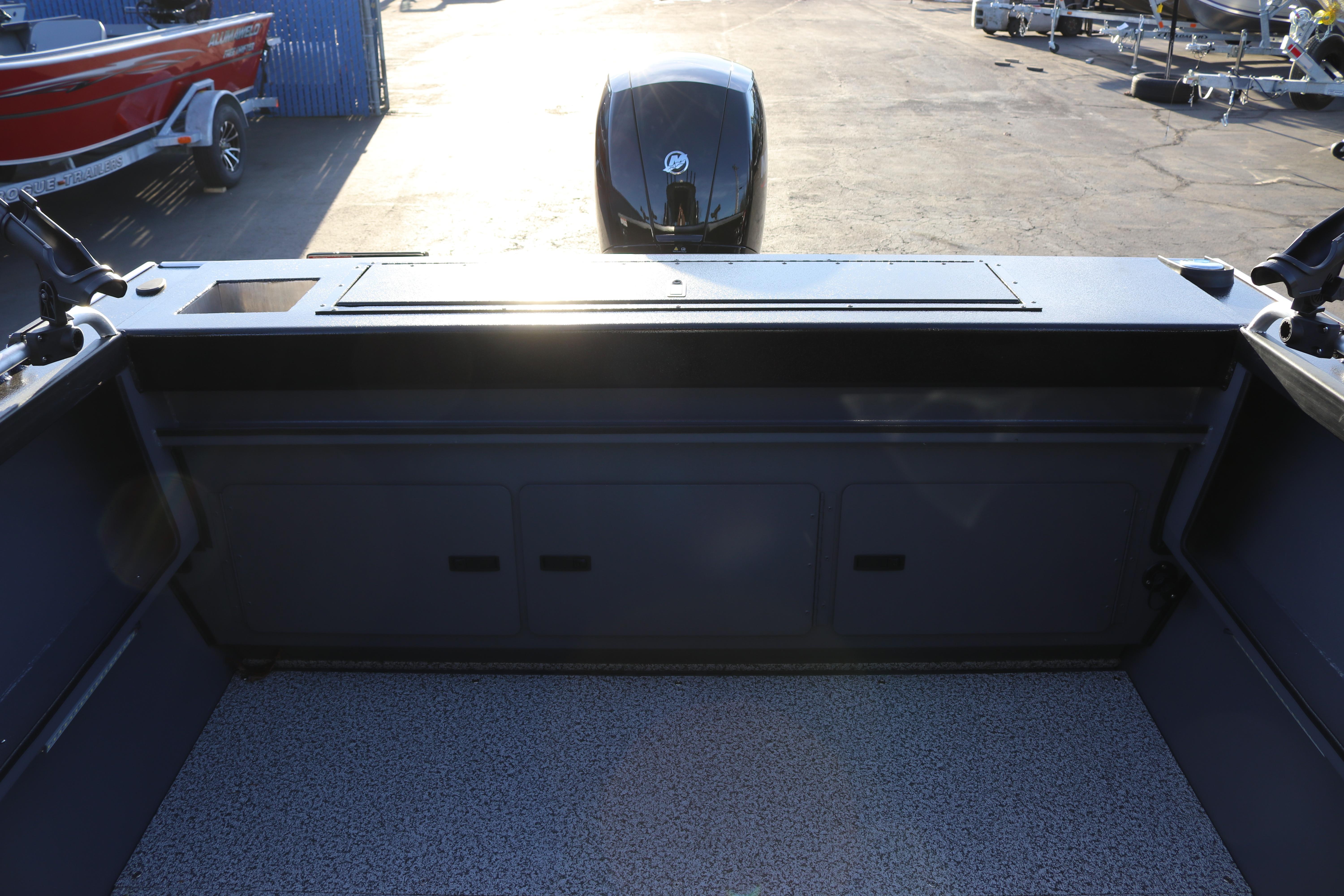 2026 Alumaweld Stryker X202 boat interior with motor, docked in sunlight.