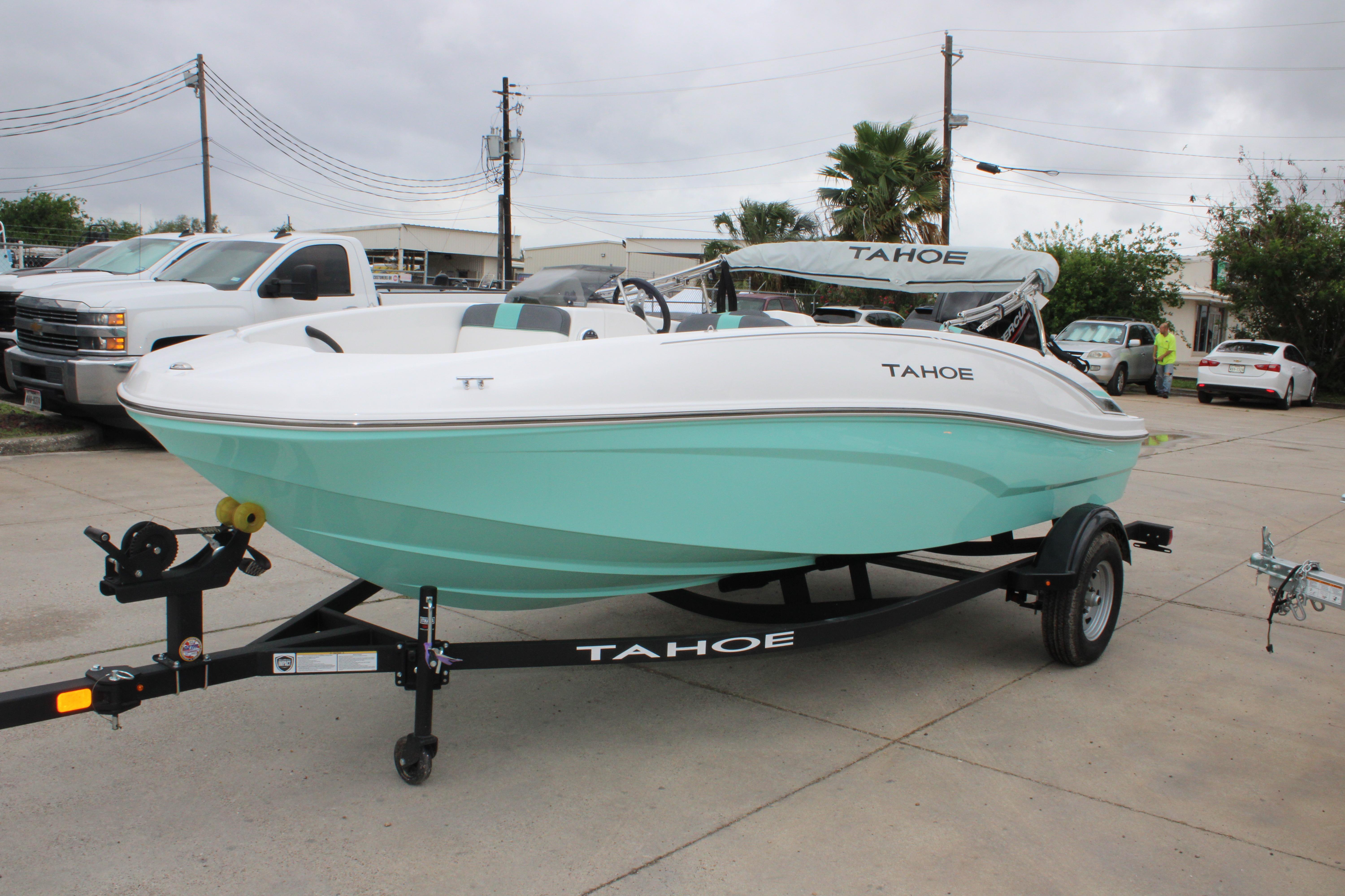 2026 Tahoe T16 boat in mint green on trailer, parked outdoors.