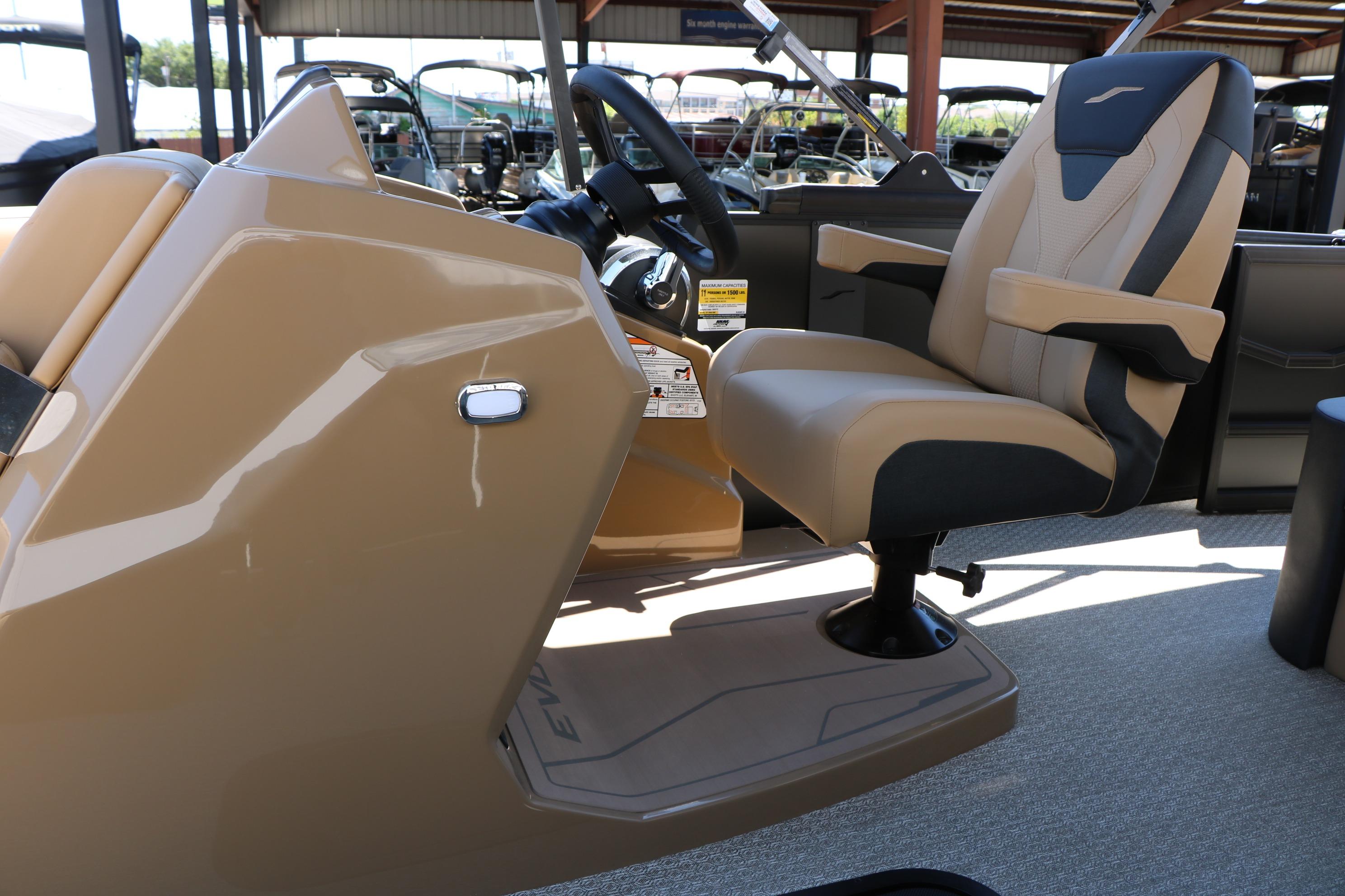 Captain's chair and console of 2026 Evotti 521CS boat, featuring modern design.