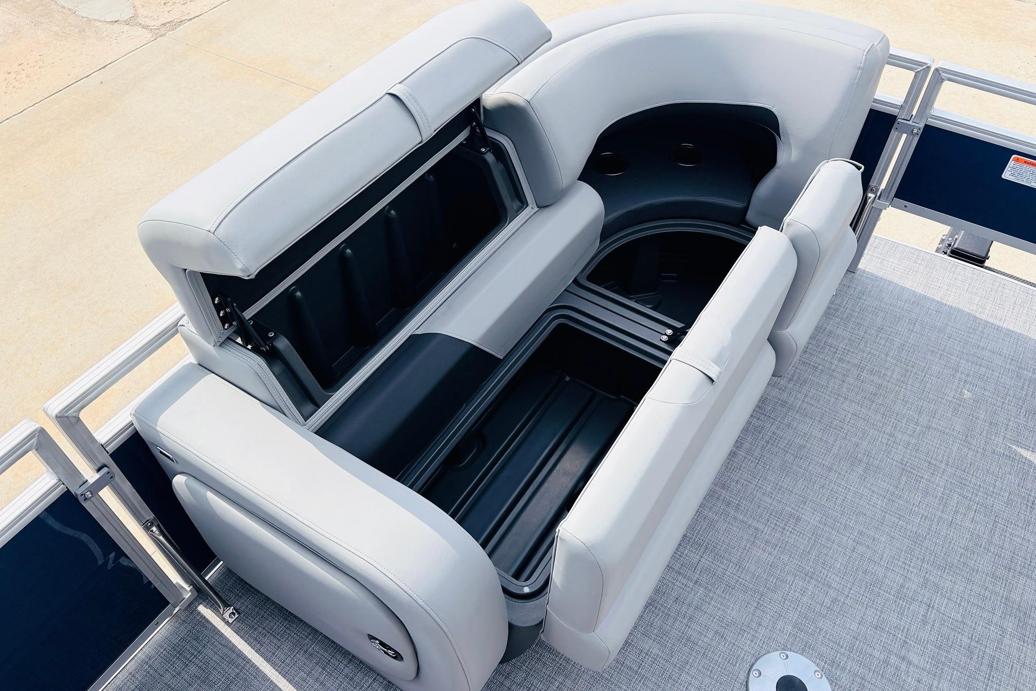 2026 Sun Tracker SportFish 22 DLX boat seating with storage compartments open.