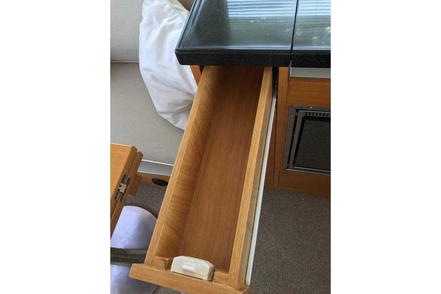 Open wooden drawer in 2014 Rhea Trawler 36 Timonier, showcasing interior storage space.
