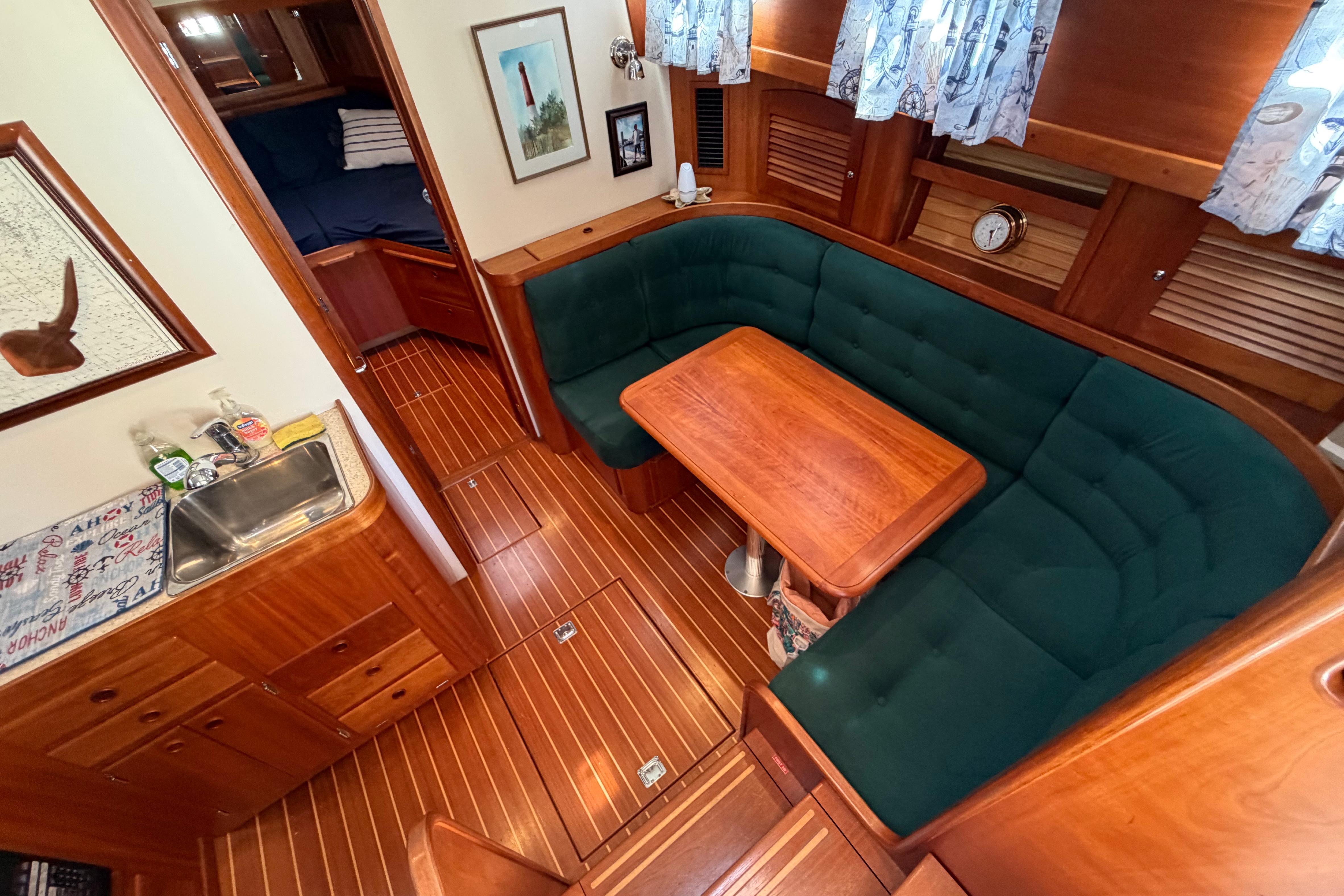 Interior of 2000 Sabreline 36 Express yacht with wood finish and cozy seating area.