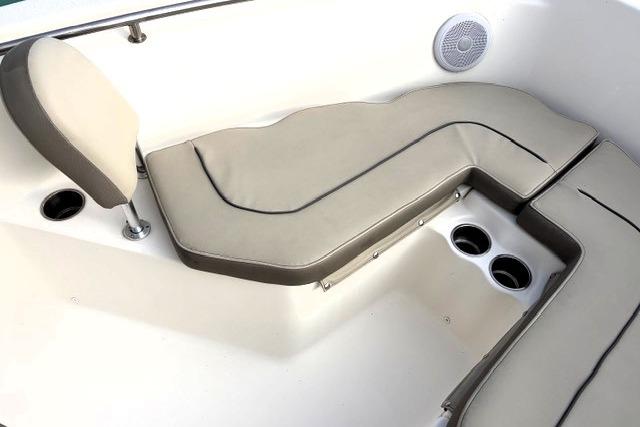 2023 Key West 203 FS boat interior with cushioned seating and cup holders.