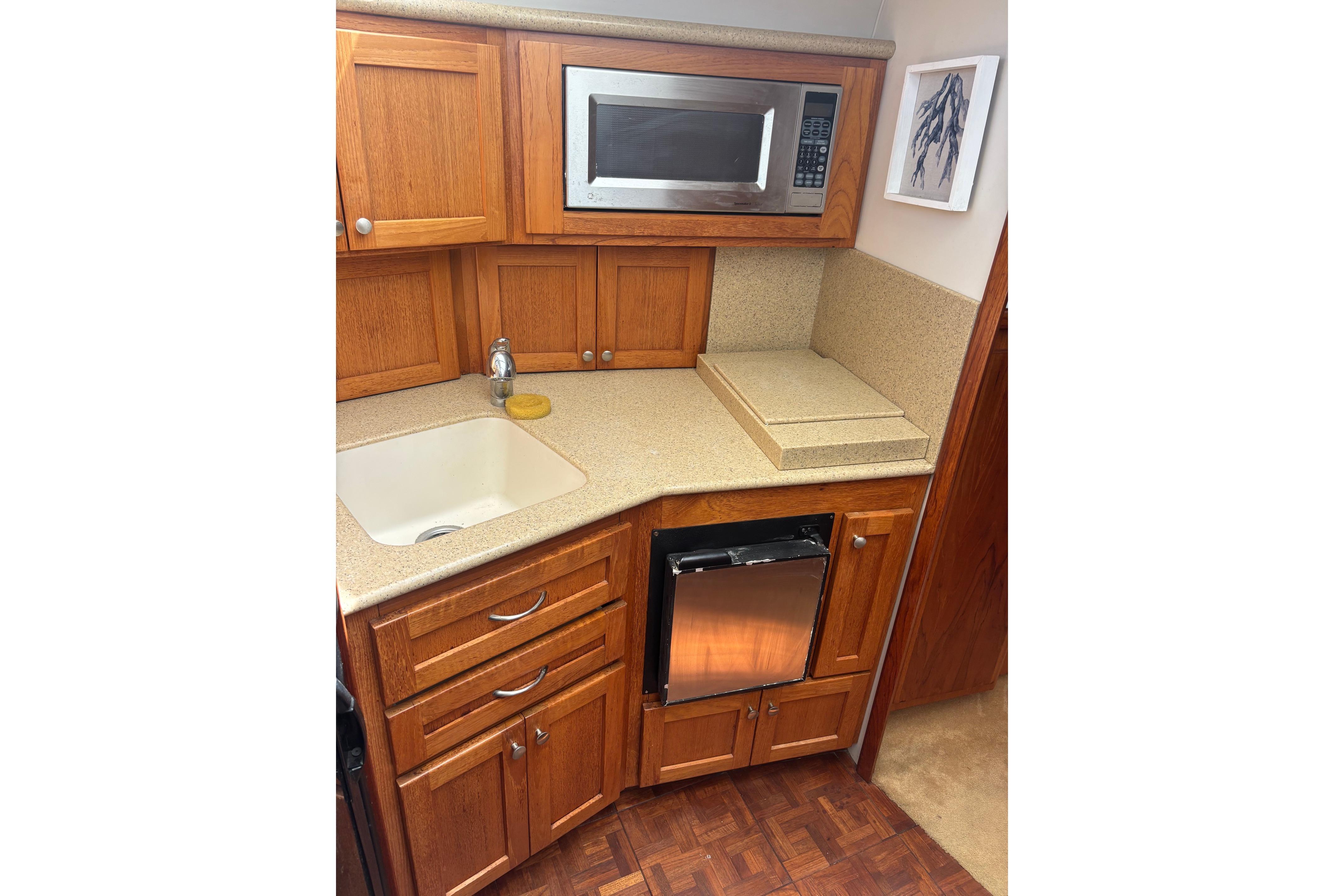 1995 Carver 356 Aft Cabin Motor Yacht kitchen with wood cabinets and modern appliances.