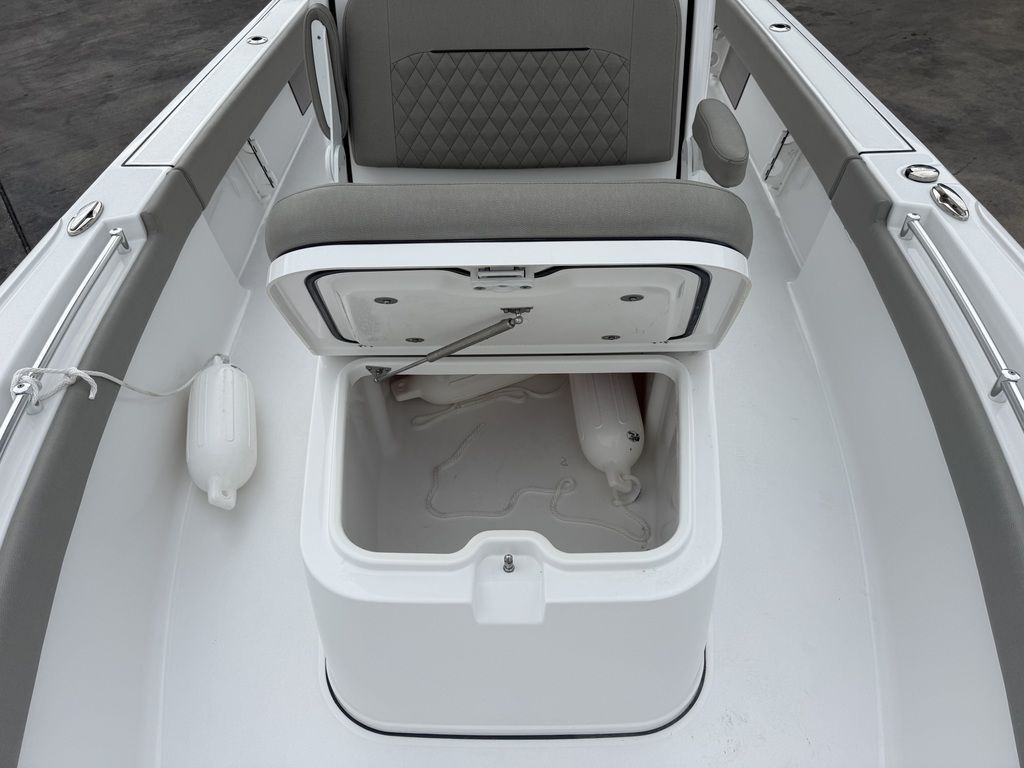 The image shows the seating area of a Sportsman Masters 247OE Bay Boat with storage underneath.