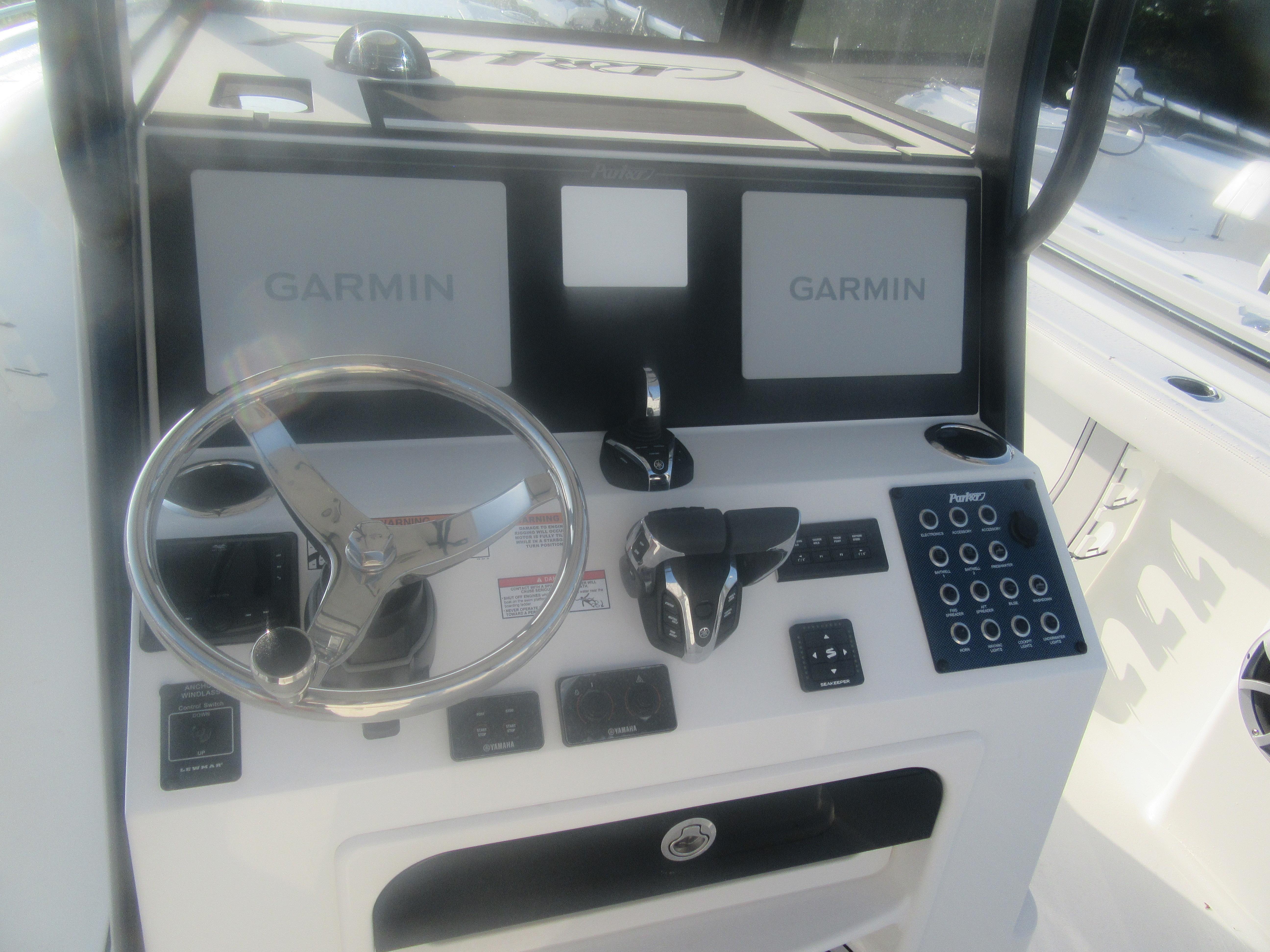 2025 Parker 2900 Center Console boat dashboard with Garmin displays and steering wheel.