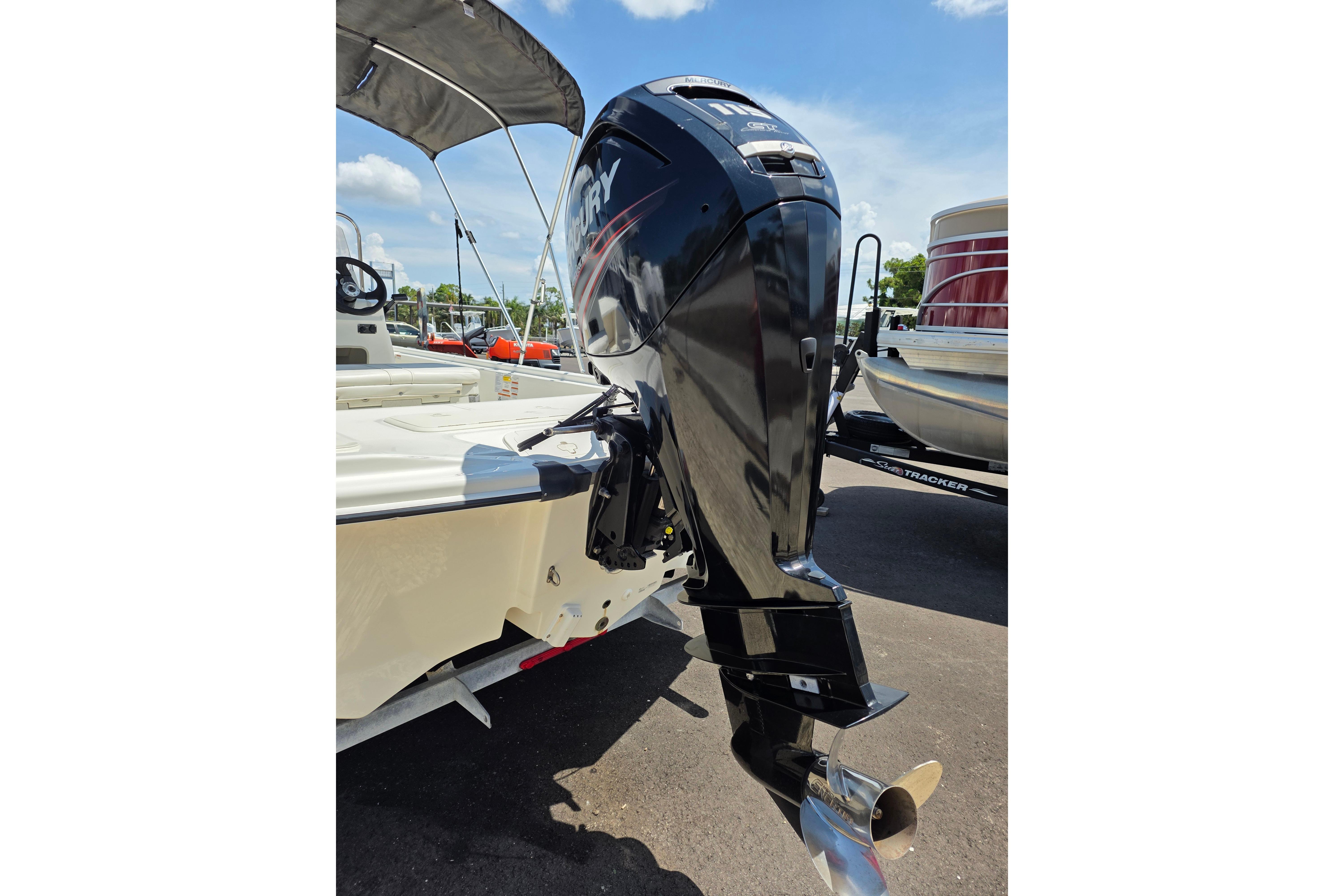 2018 Mako Pro Skiff 19 CC with Mercury outboard motor, parked on a sunny day.