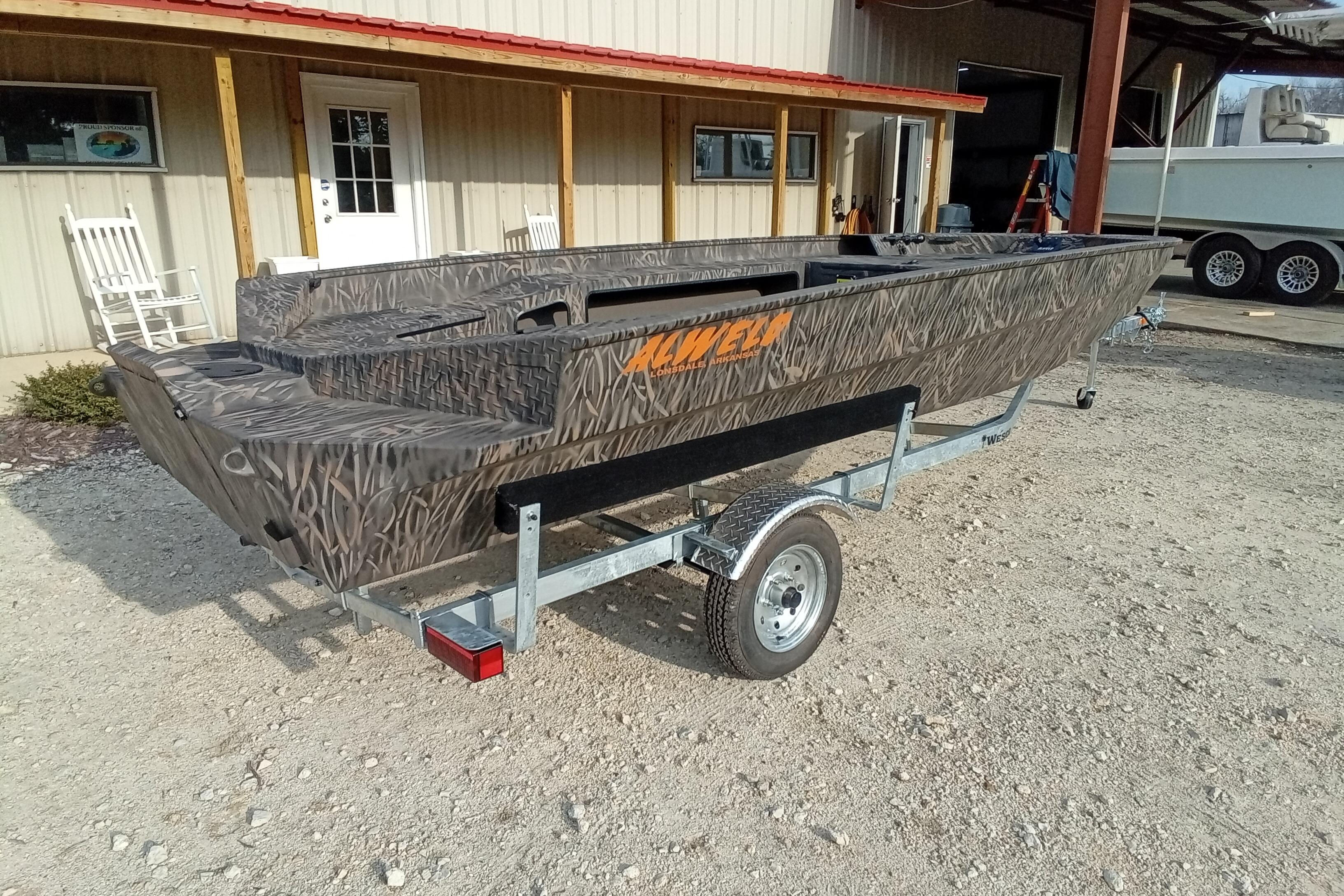 2026 Alweld 1756 Invader boat on trailer, camo design, parked outside a building.