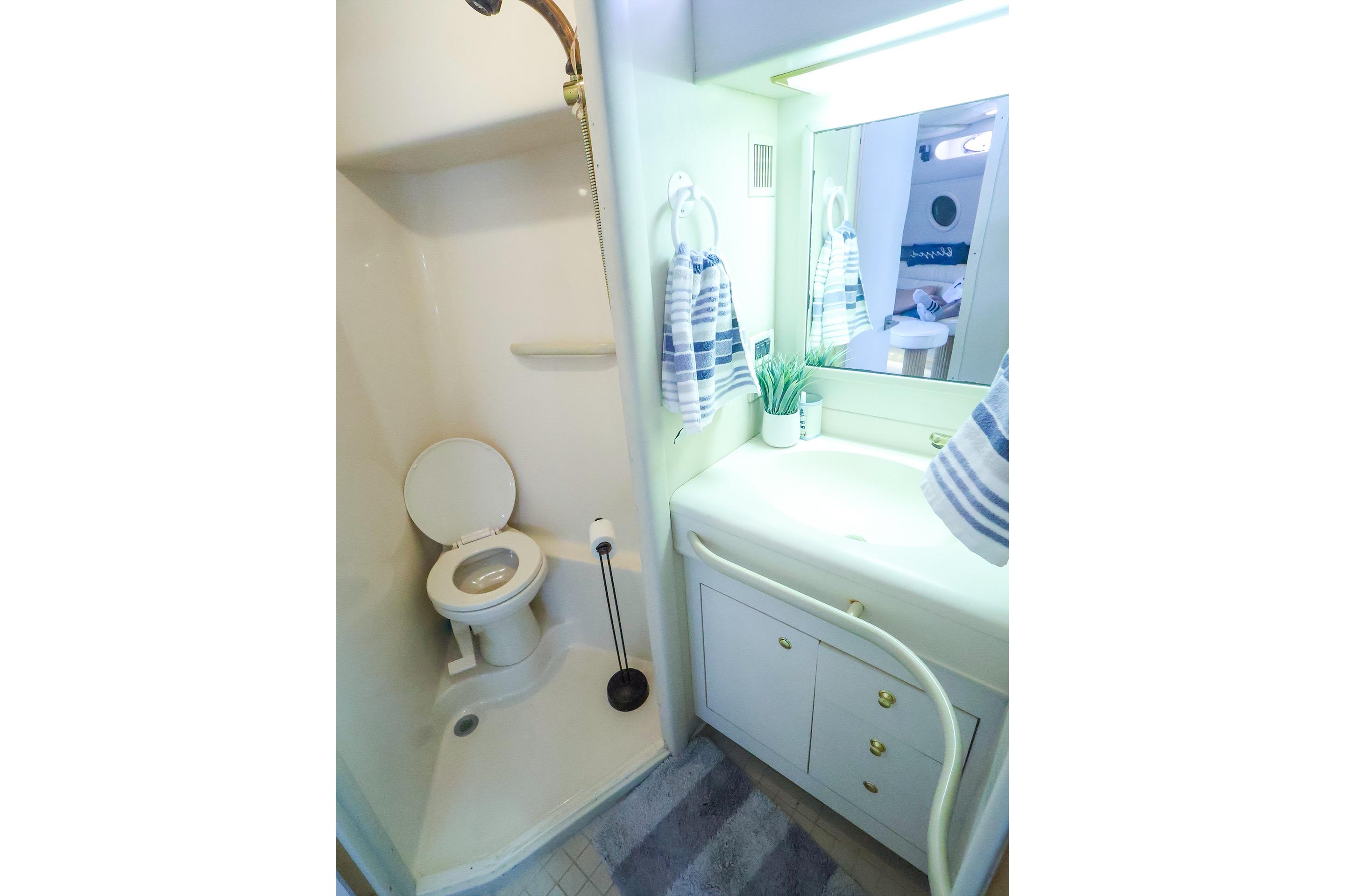 Bathroom interior of 1998 Sea Ray 500 Sundancer yacht, featuring shower and vanity.