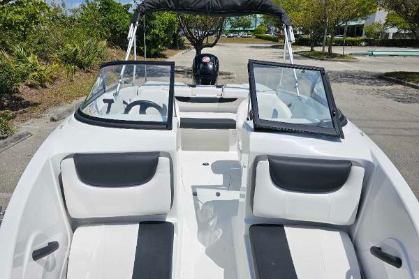 2025 Tahoe 185 S boat interior with open windshield, black and white seating, and steering wheel.