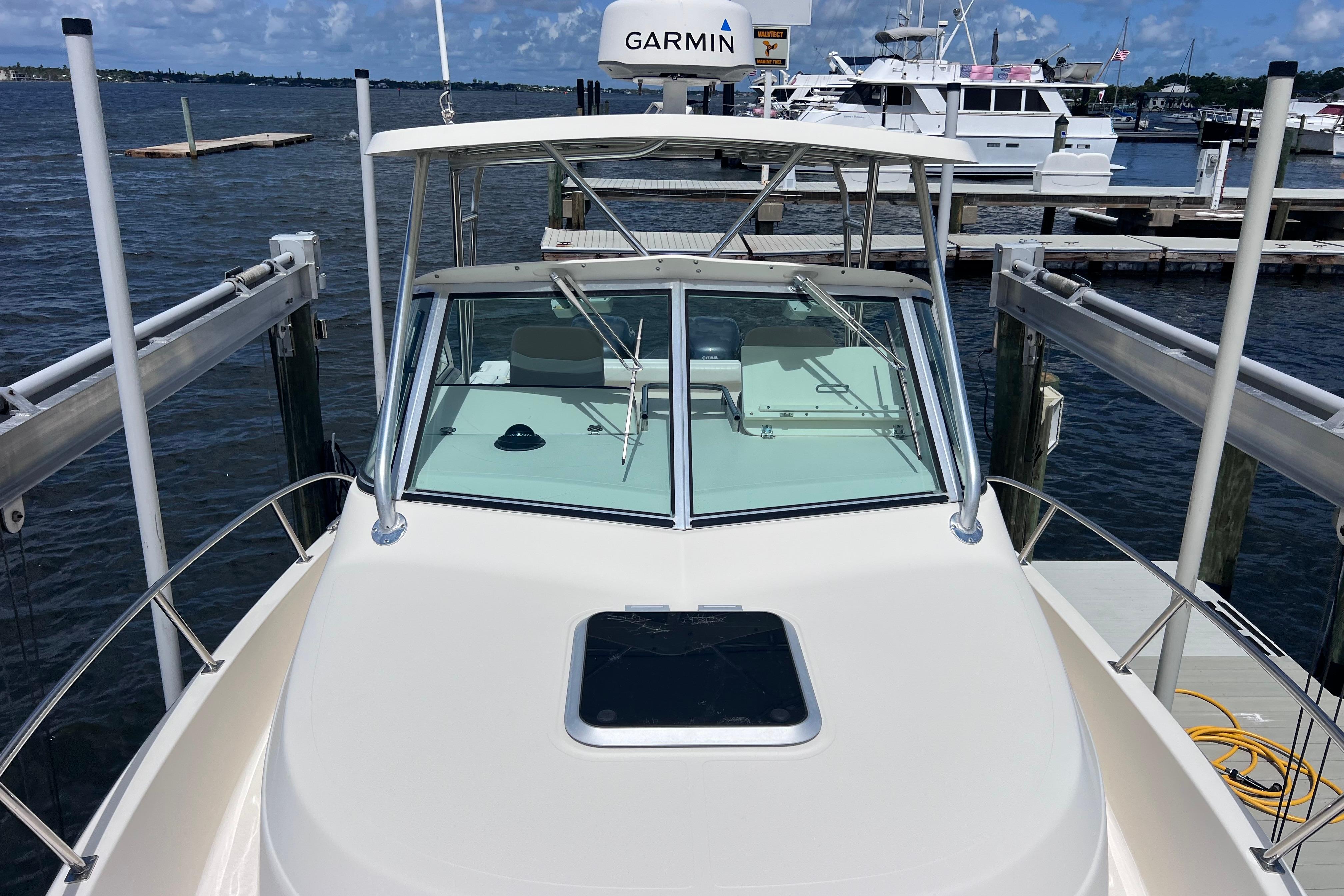 2004 Pursuit 2870 Walkaround boat docked at marina with Garmin equipment.