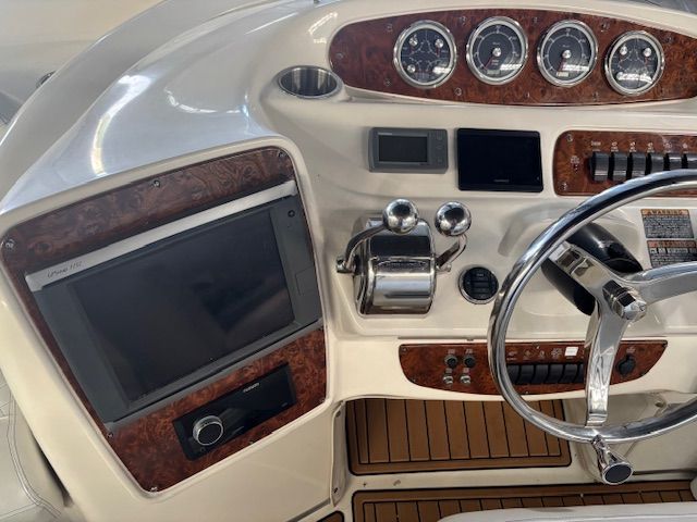 The image shows the helm of a 2004 Meridian 341 Sedan with wood paneling and instruments.