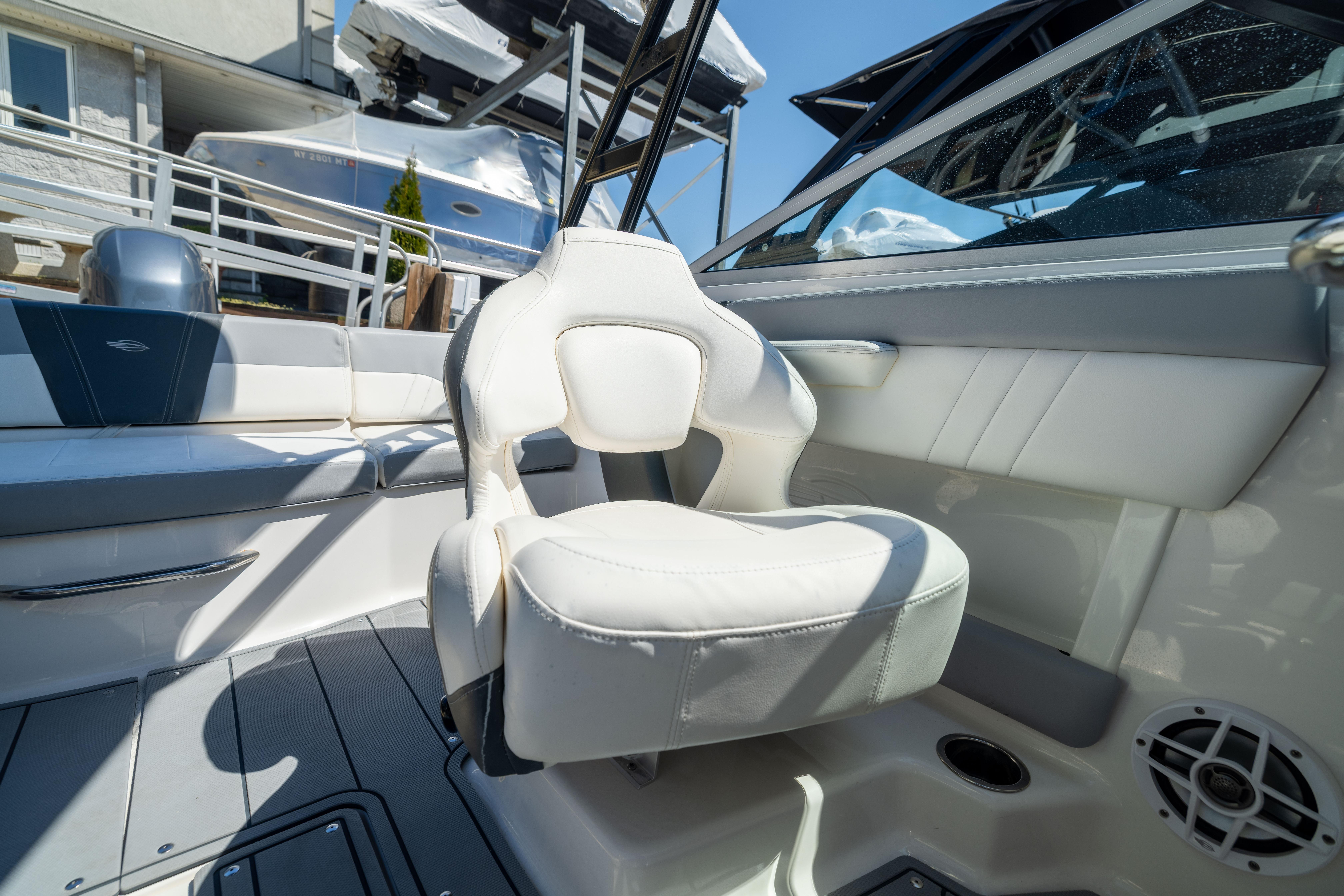 Interior of 2022 Chaparral 21 SSi OB boat with white seating and modern design.