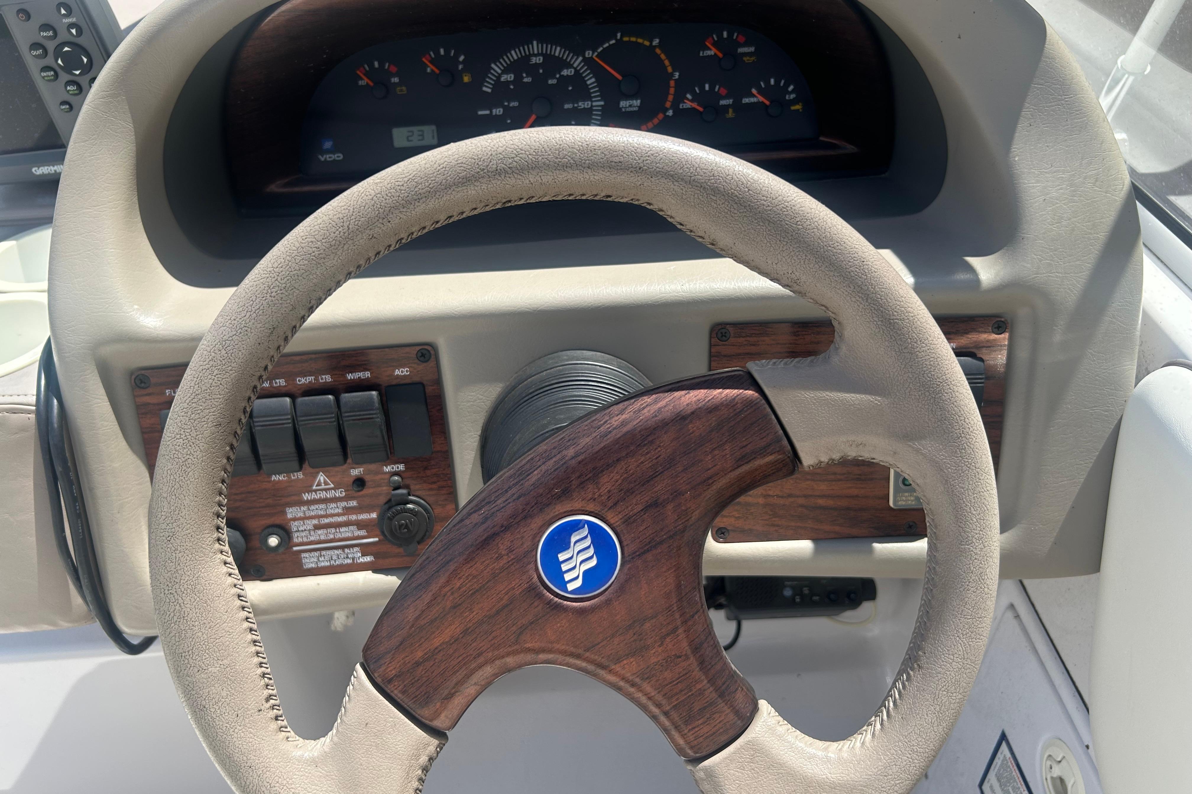 Steering wheel and dashboard of a 1998 Four Winns 258 Vista boat.