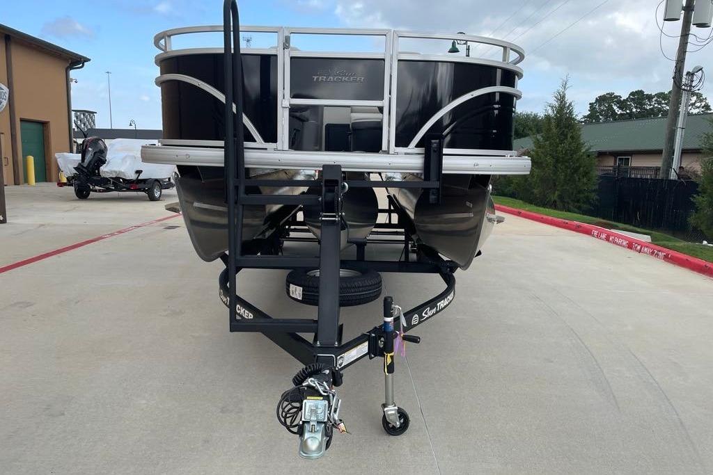 2026 Sun Tracker Fishin' Barge 22 XP3 on trailer, parked outdoors.