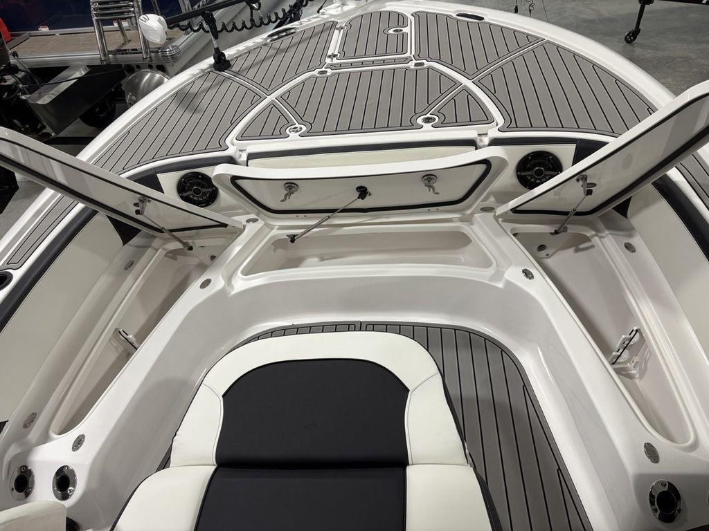 2026 Tidewater 2700 CB boat interior with open storage compartments and cushioned seating.