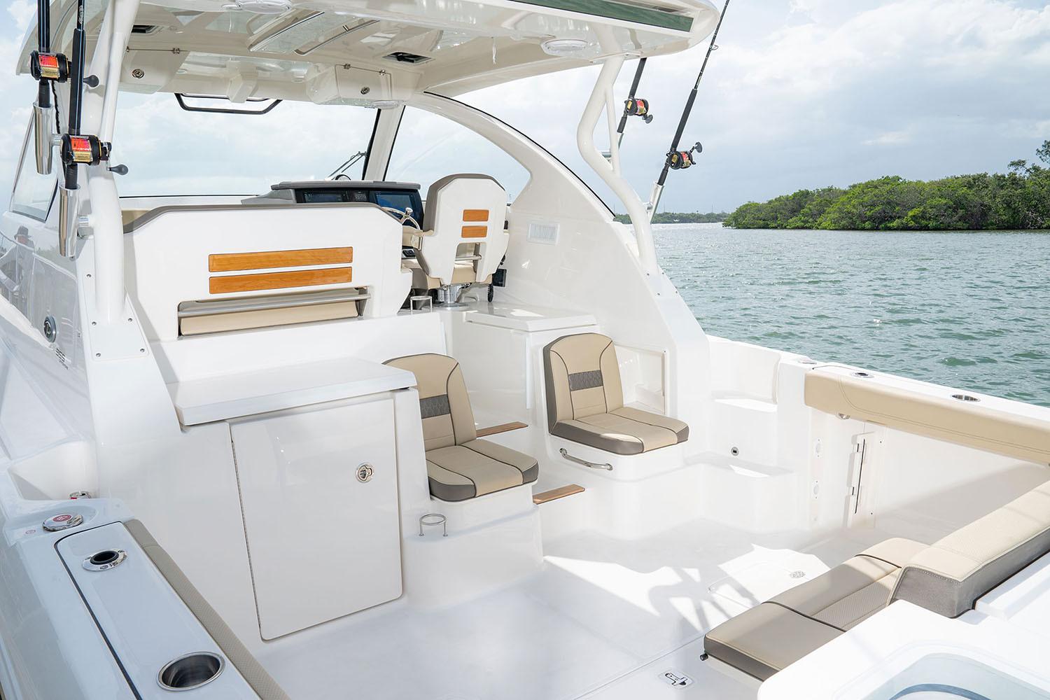 Manufacturer Provided Image: 2025 Pursuit OS 355 Offshore boat interior with seating, on a calm water backdrop.