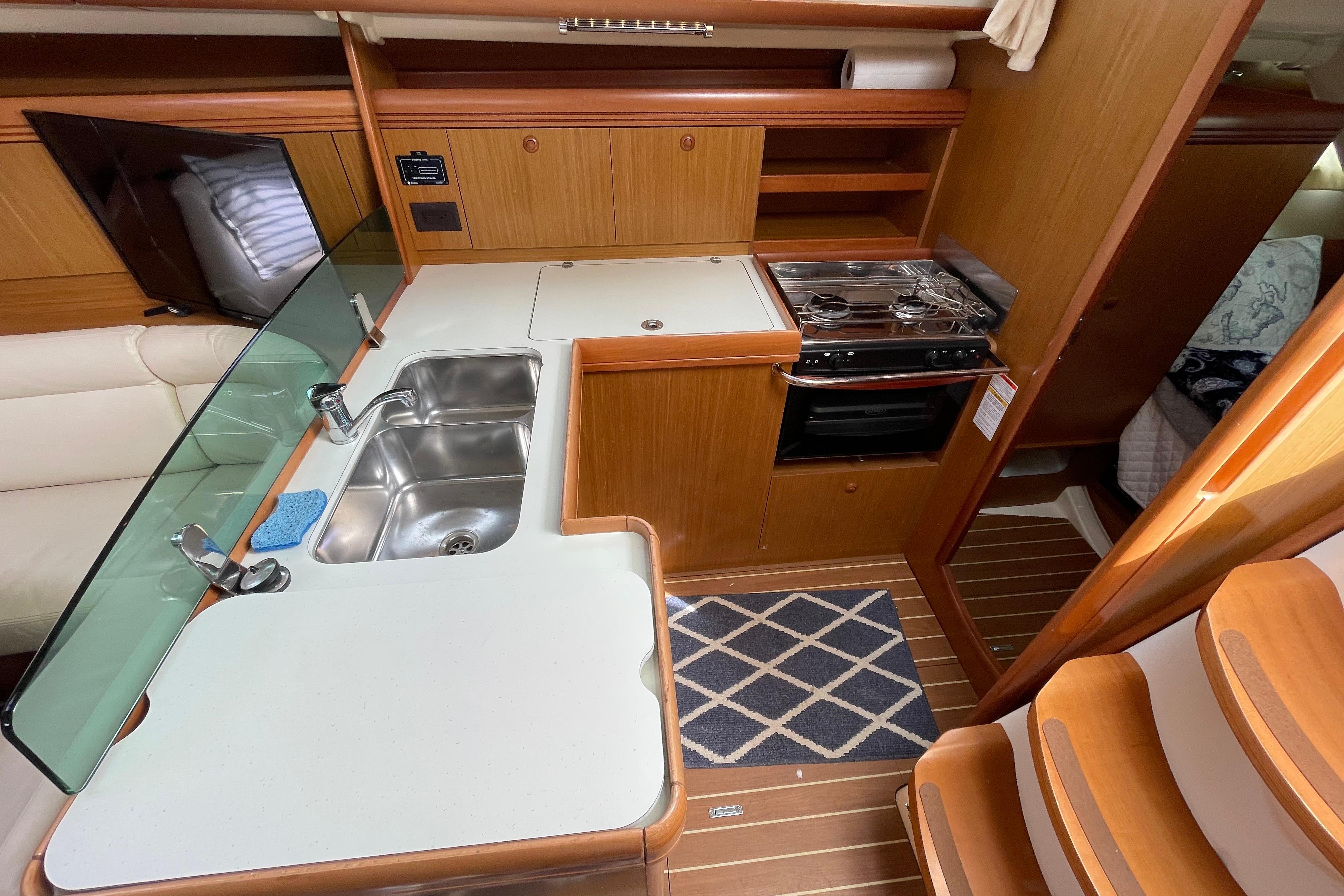 2007 Jeanneau Sun Odyssey 39 DS yacht interior with kitchen, sink, and stove.