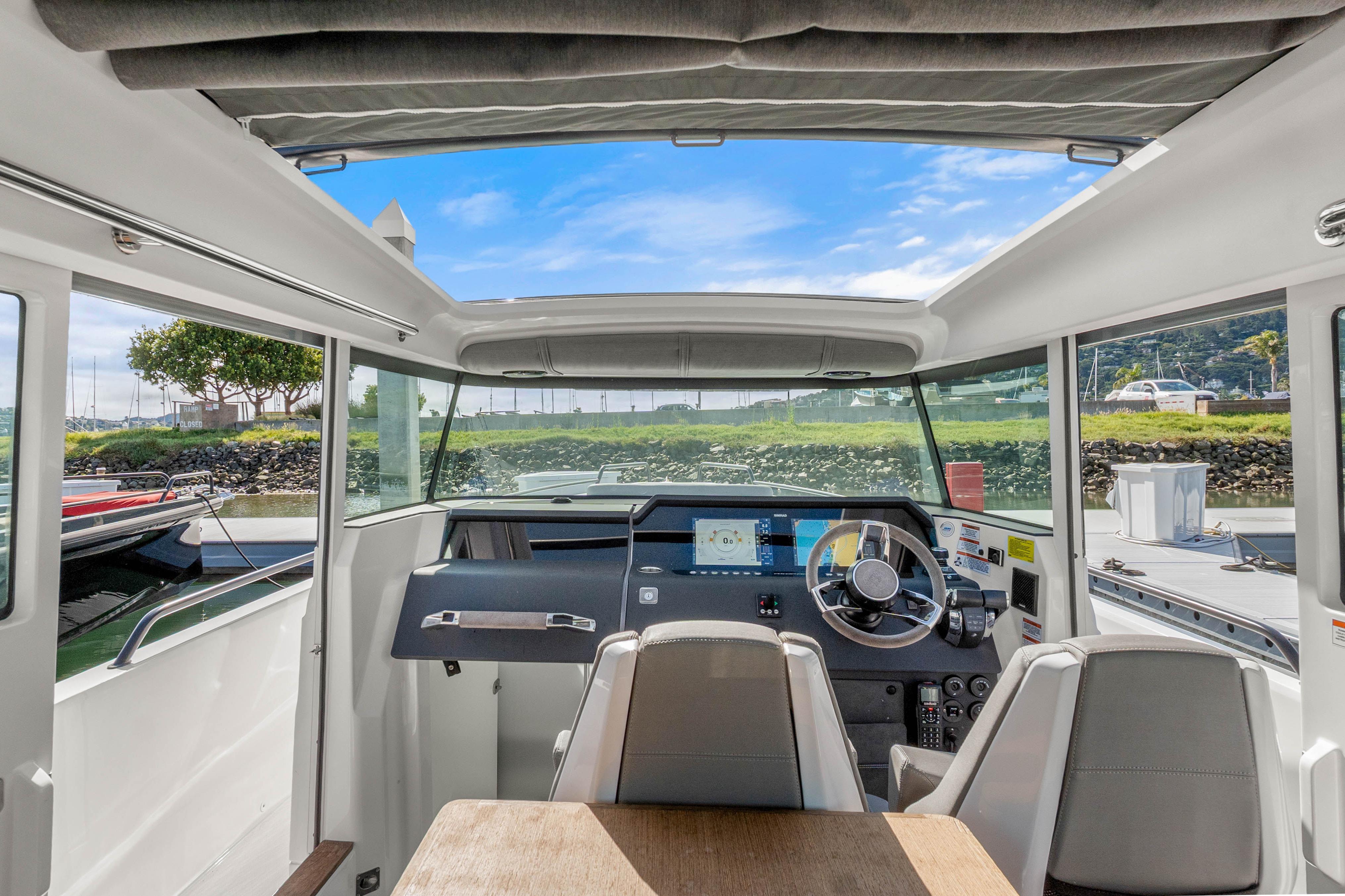 Interior view of 2021 Axopar 37 XC Cross Cabin boat with modern dashboard and seating.