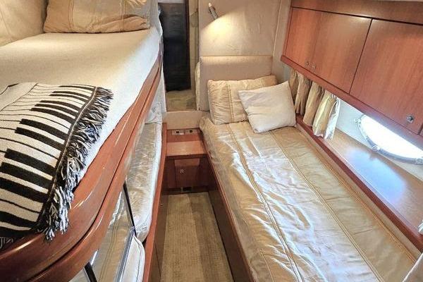 Luxurious cabin interior of 2005 Sunseeker Manhattan 66 yacht with cozy twin beds.